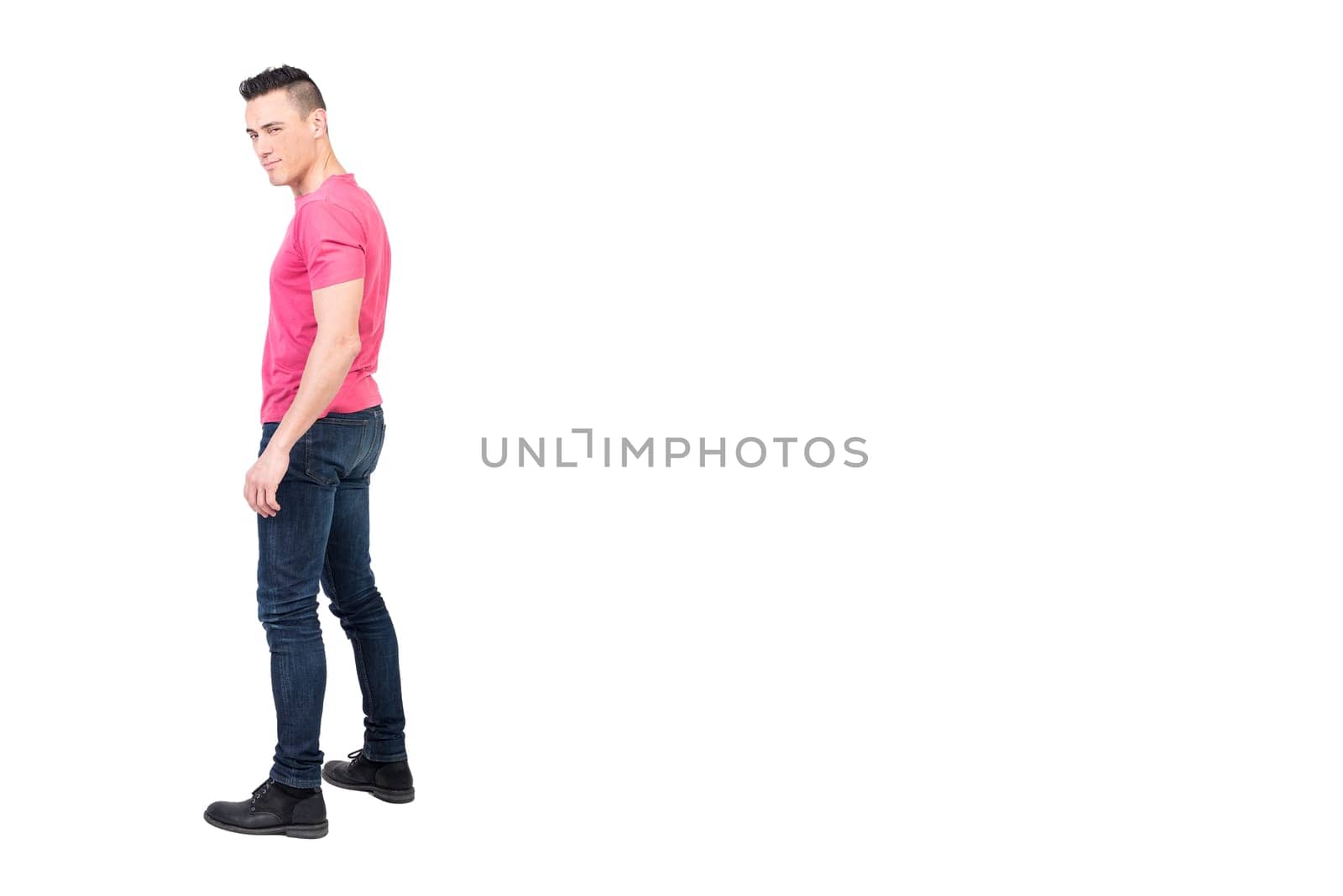 Full body side view of masculine male model winking at camera against white background