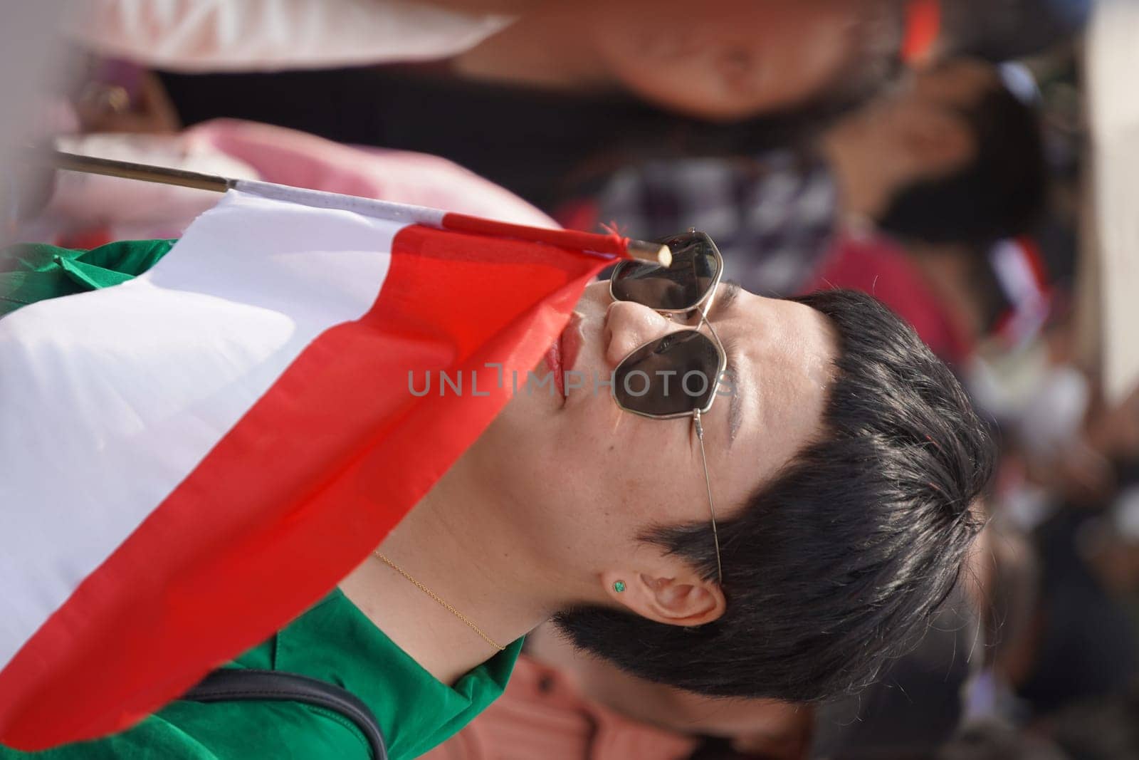 17 August 2024, Jakarta, Indonesia. The atmosphere near the Jakarta Palace during Indonesia's Independence Day is electric, filled with patriotic fervor and national pride. Crowds of people, dressed in red and white, gather to witness the flag-raising ceremony and participate in various festivities.