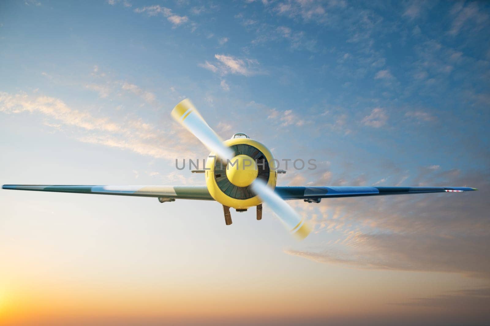 Small aircraft flying above in the blue sunset sky