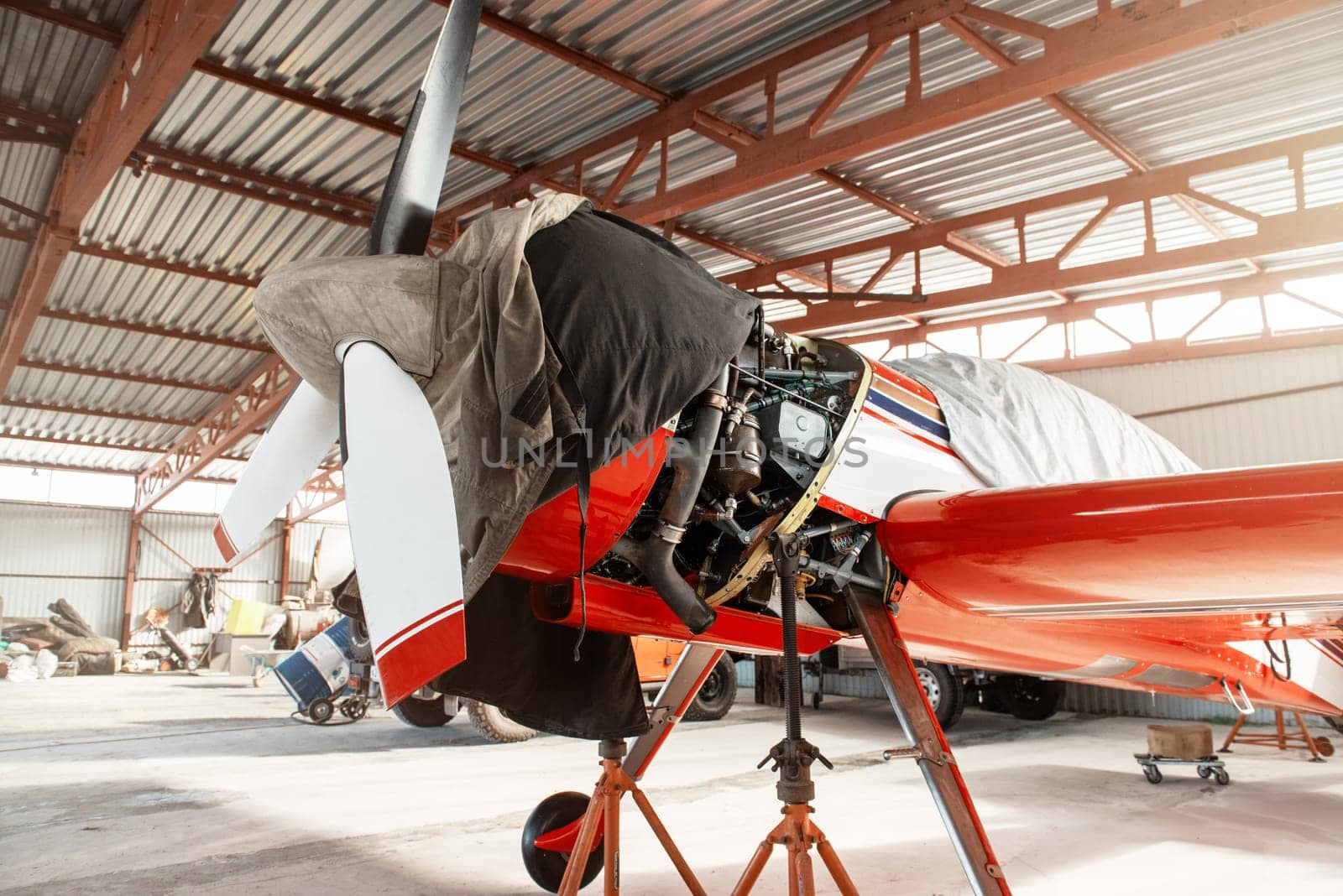 Ultralight small private aircraft airplane on repair in the hangar at the aerodrome airport