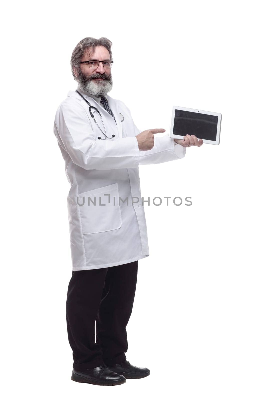 in full growth. man is a doctor pointing at the screen of a digital tablet. isolated on a white