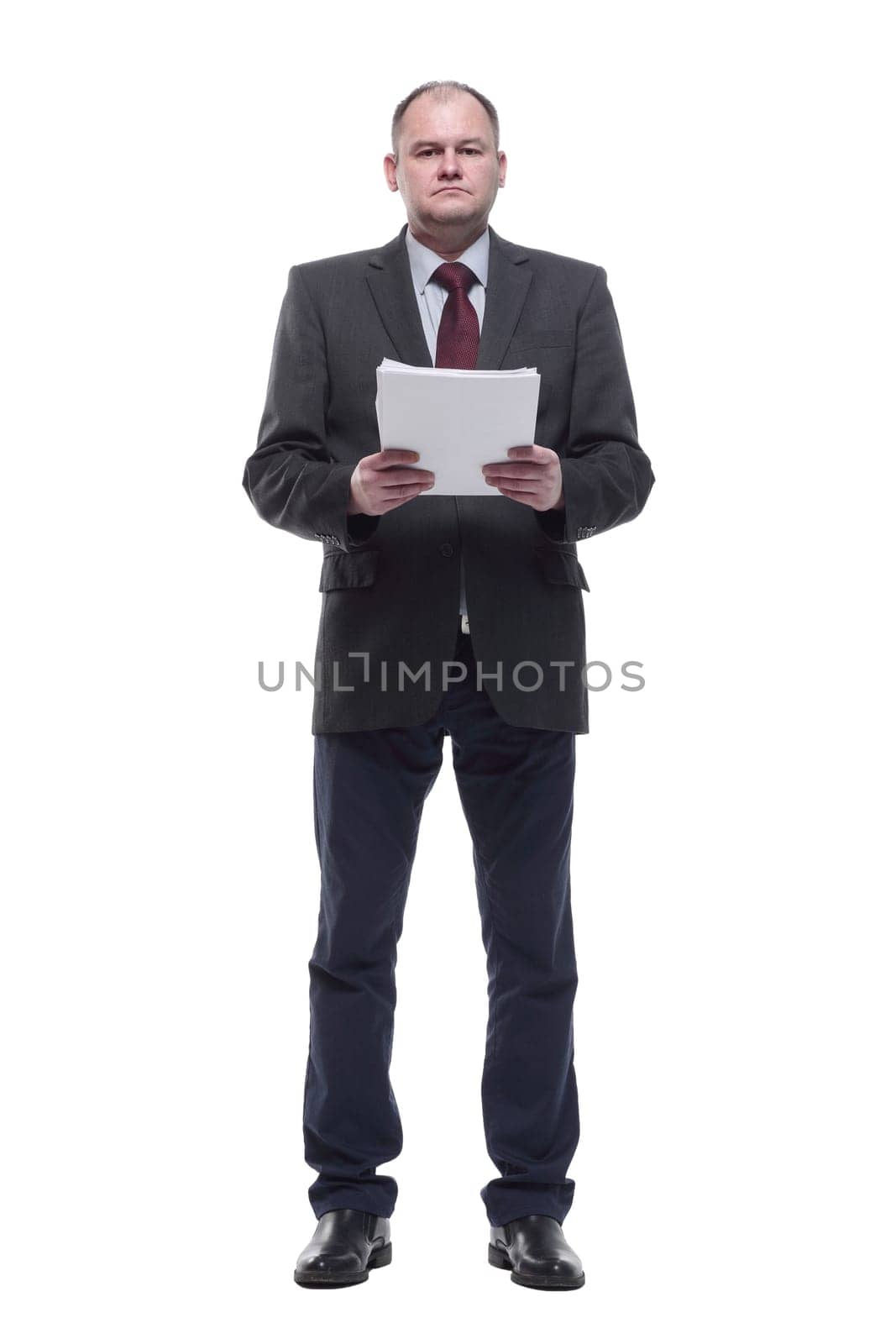 in full growth. business man with a bundle of business documents. isolated on a white background.