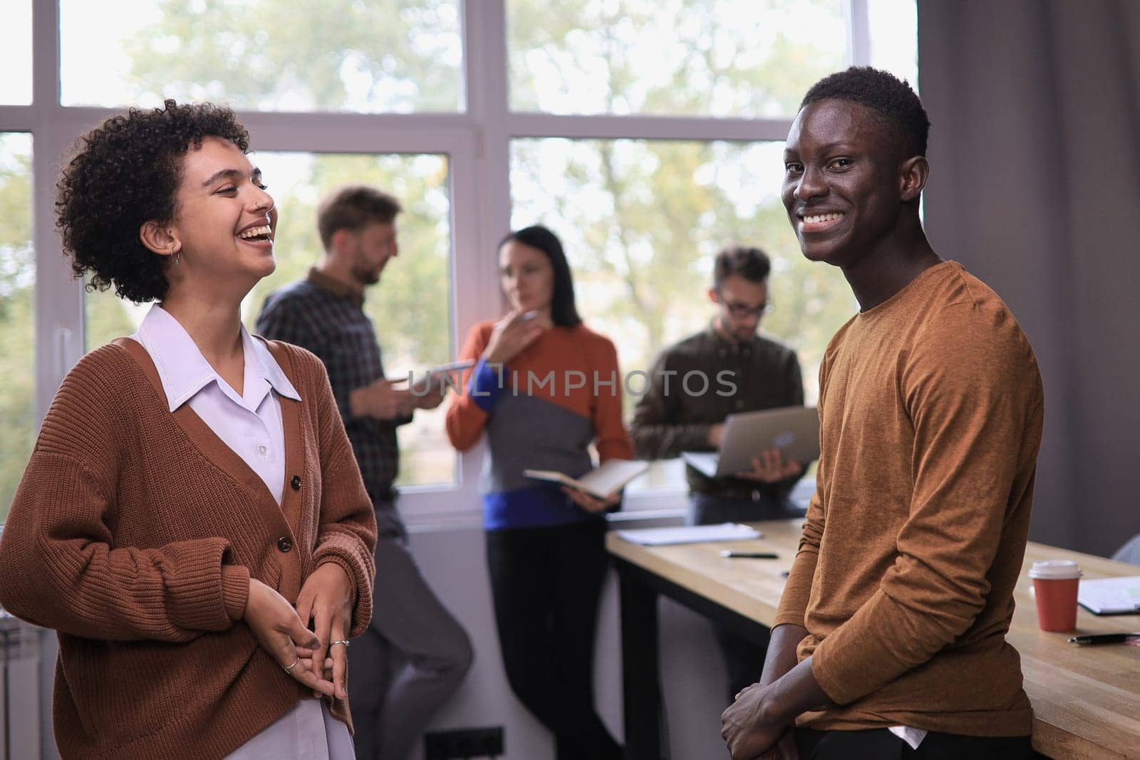 two professional businessmen discussing and using desktop computer in office by asdf