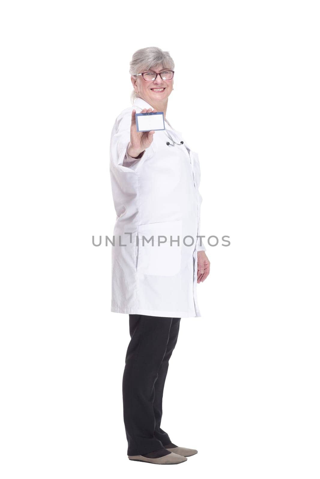 in full growth. experienced medical doctor woman showing her visiting card. isolated on a white background.