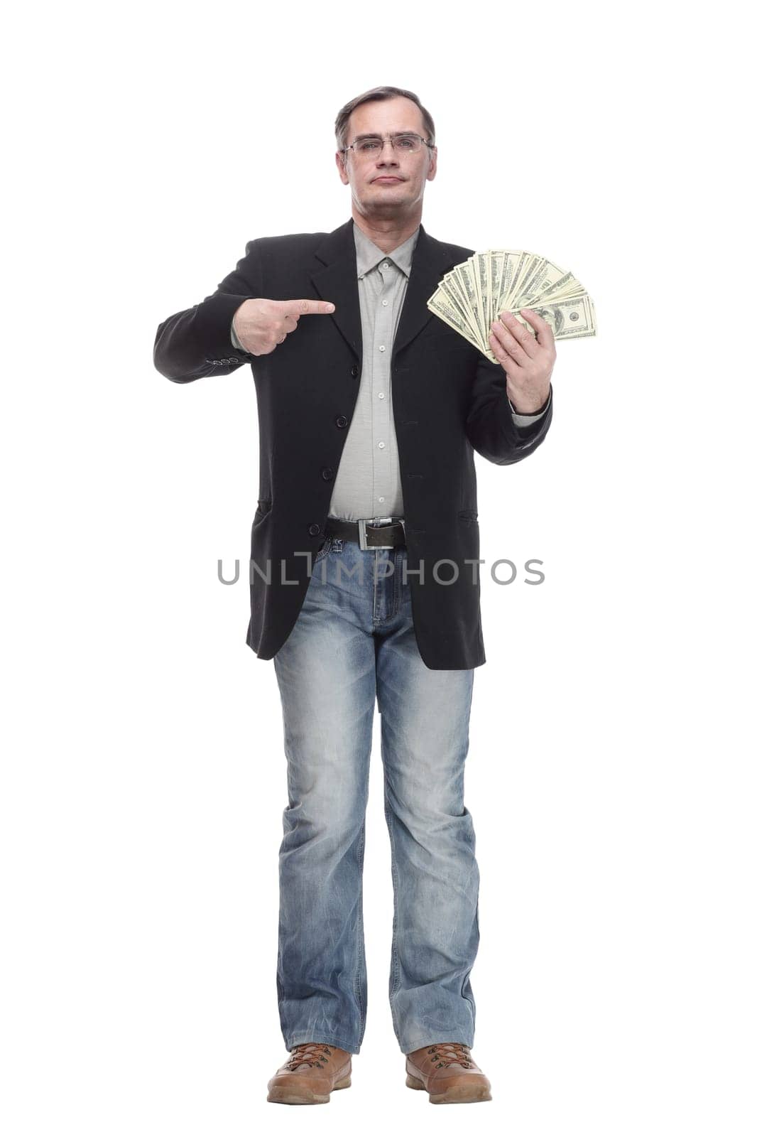 in full growth. serious business man with dollar bills. isolated on a white background.