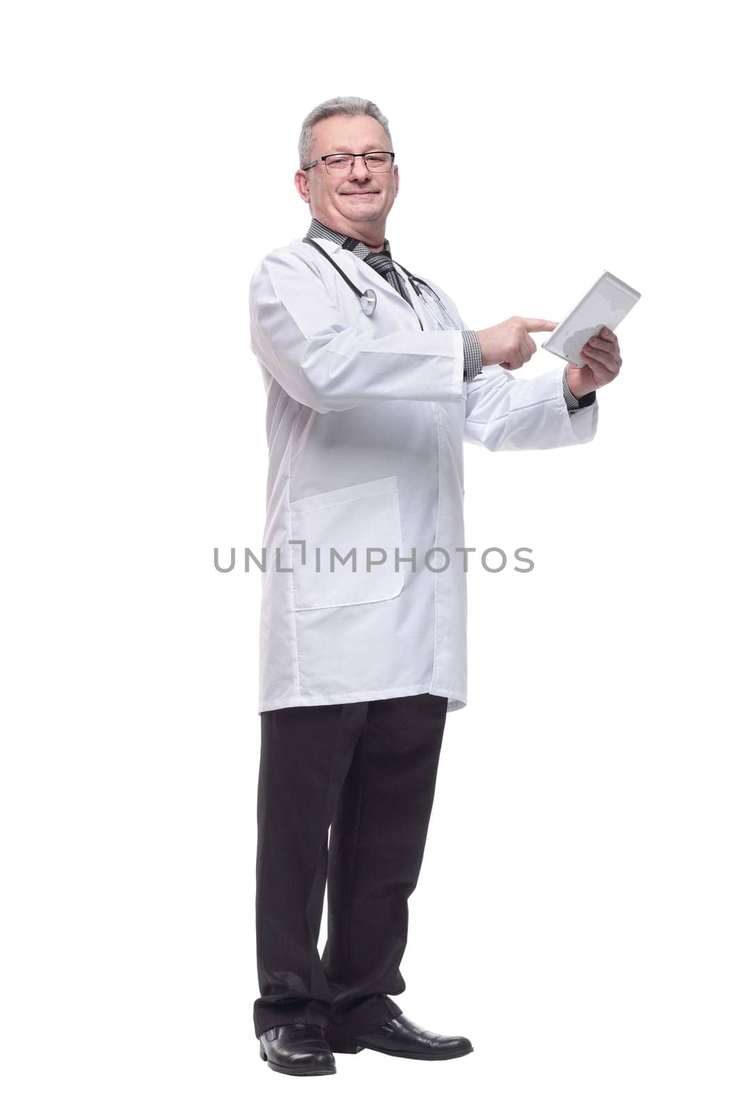 Senior doctor wearing tie and glasses using his tablet computer at work