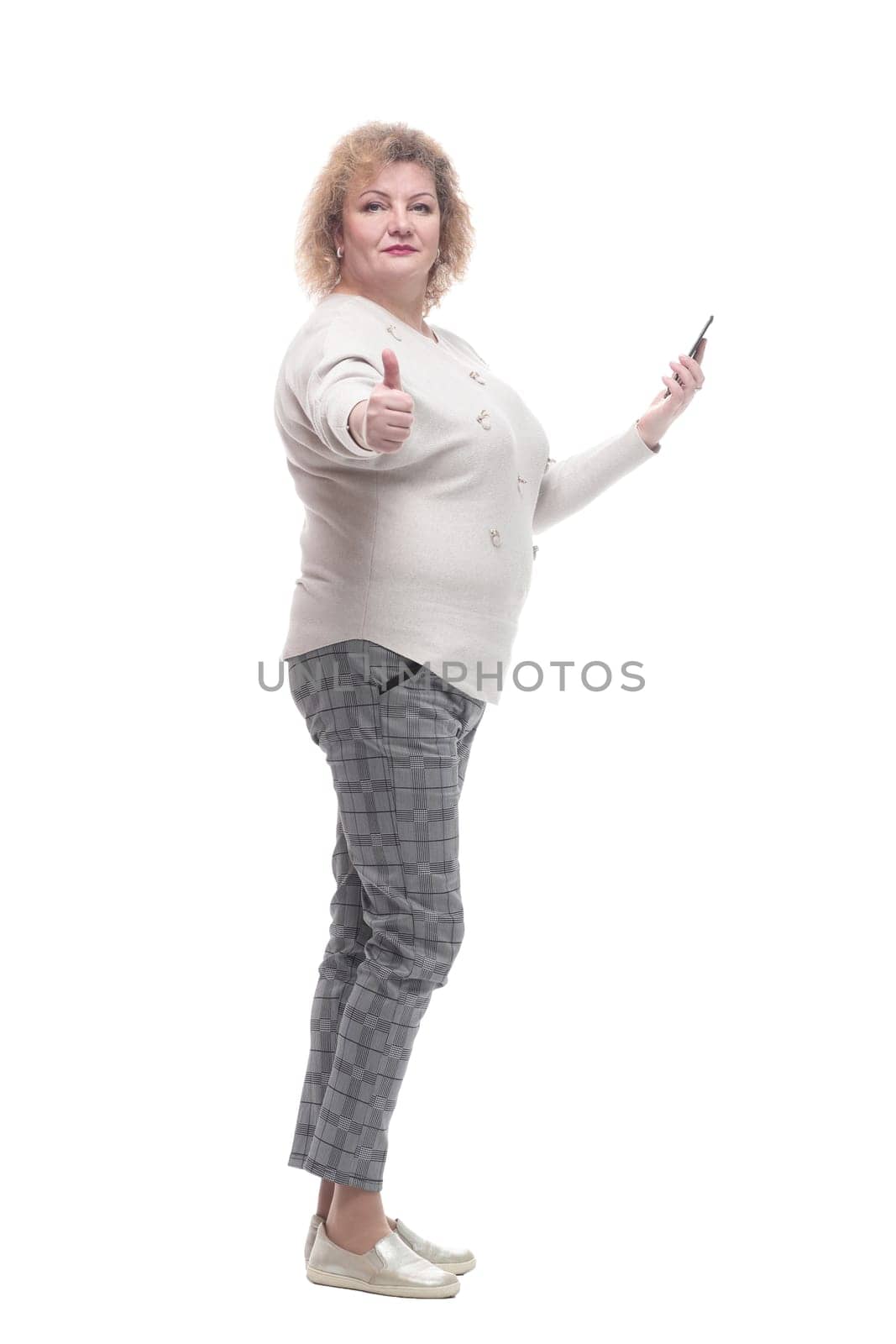 in full growth. attractive adult woman with a smartphone. isolated on a white background.