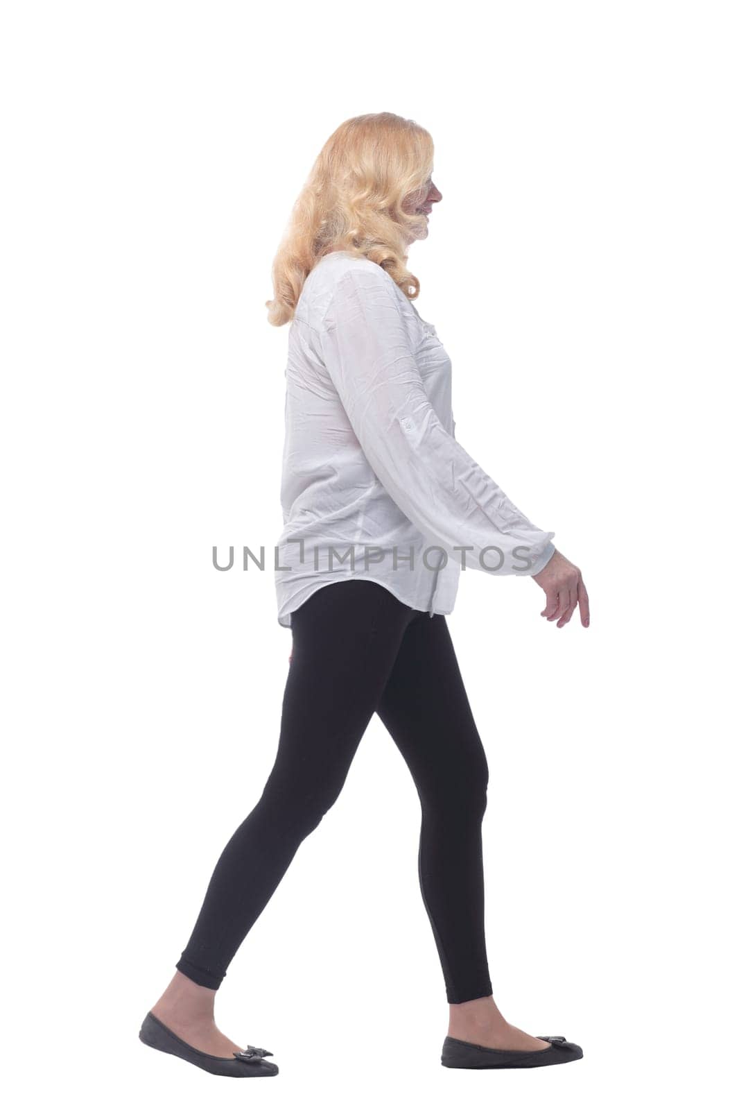 side view. woman in comfortable clothing striding forward . isolated on a white background.