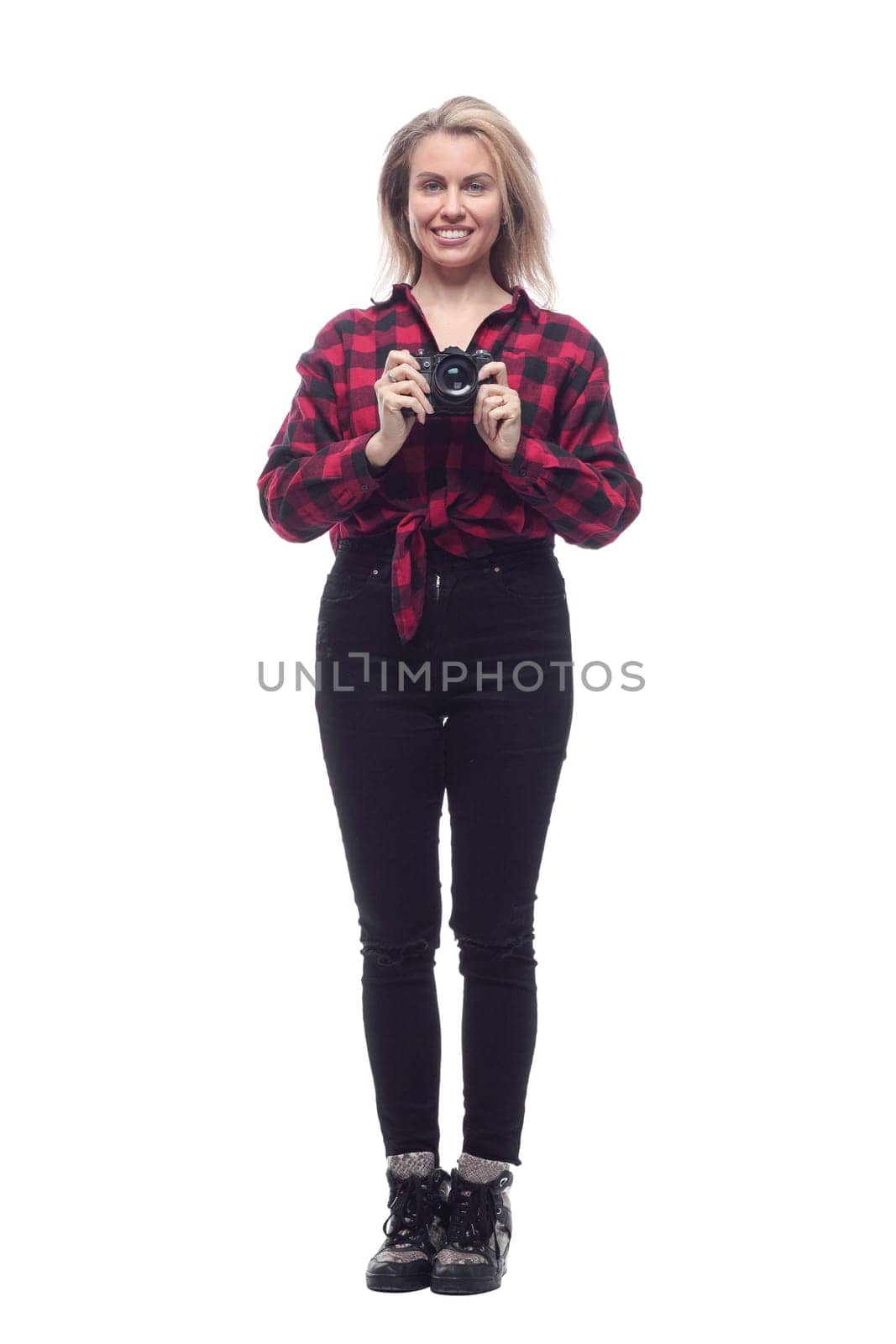in full growth.smiling young woman looking through the lens of the camera . isolated on a white background.