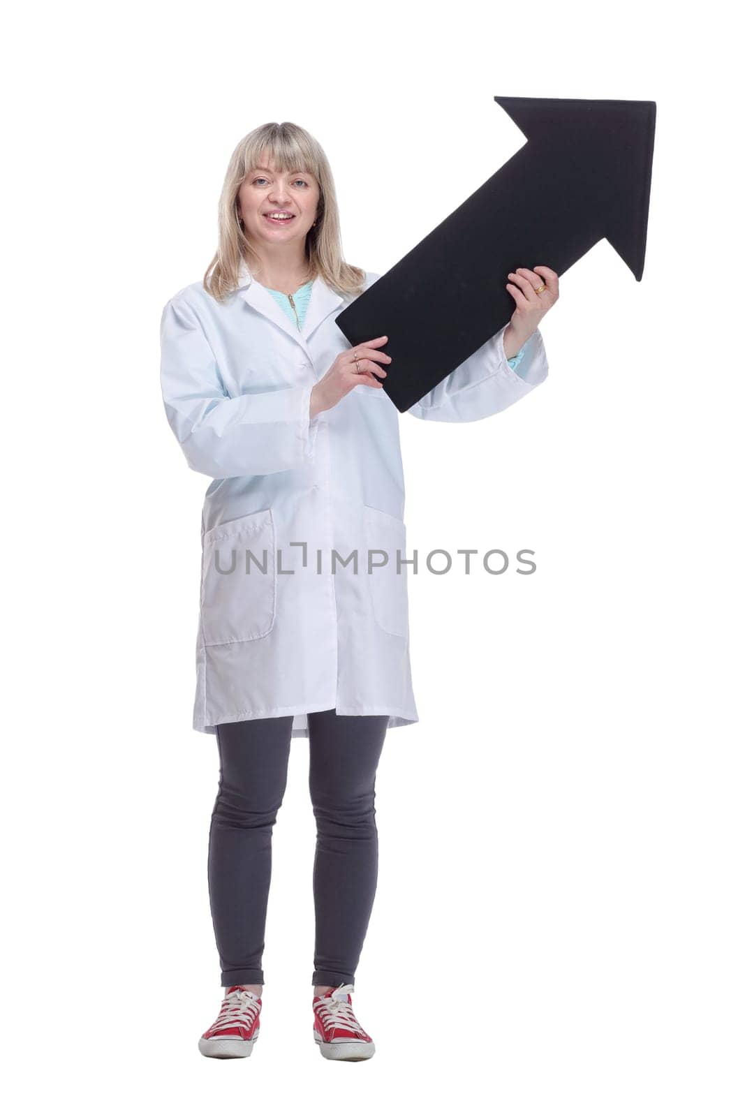 in full growth.female medic pointing in the right direction. isolated on a white background.