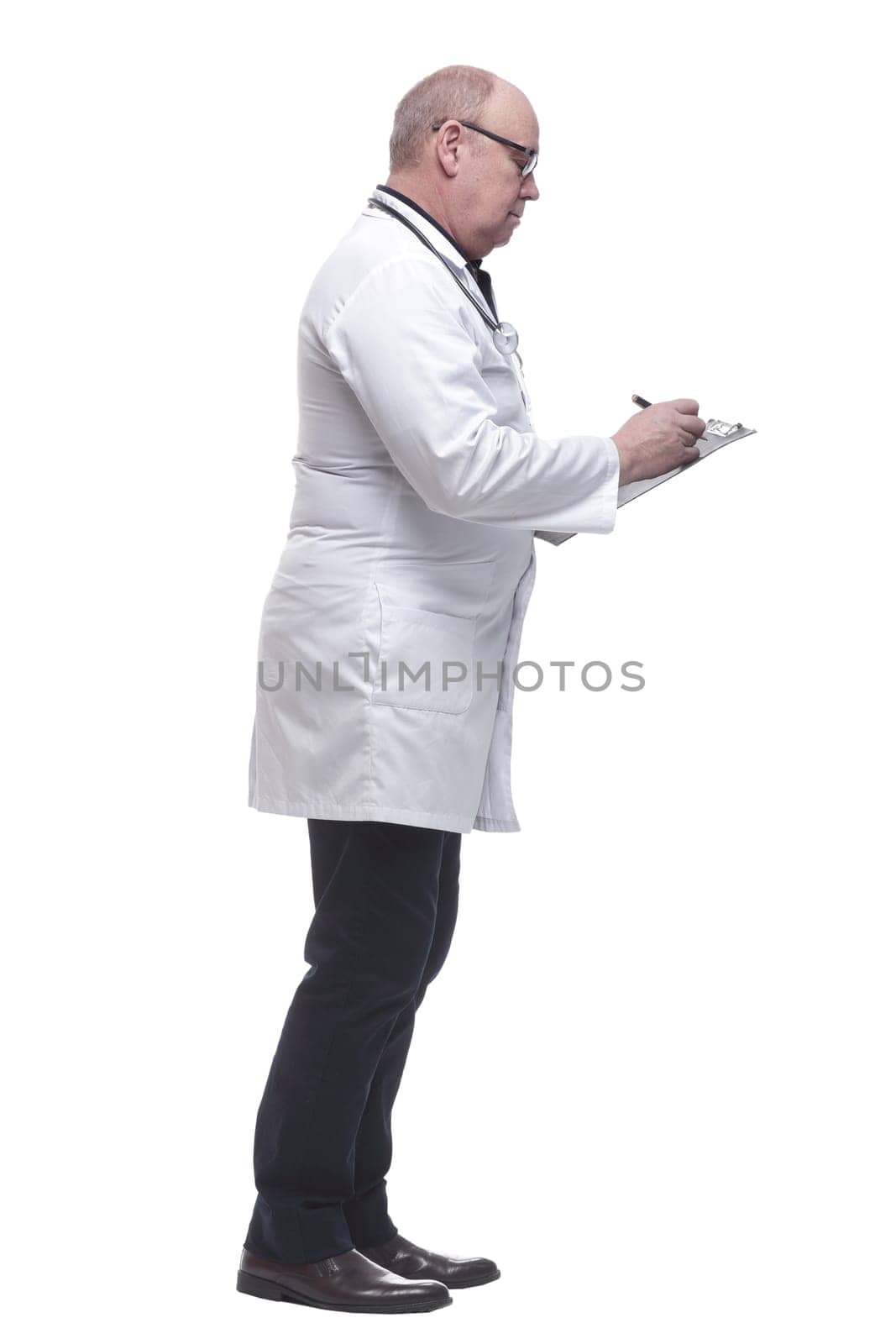 in full growth. a serious doctor writing a prescription. isolated on a white background