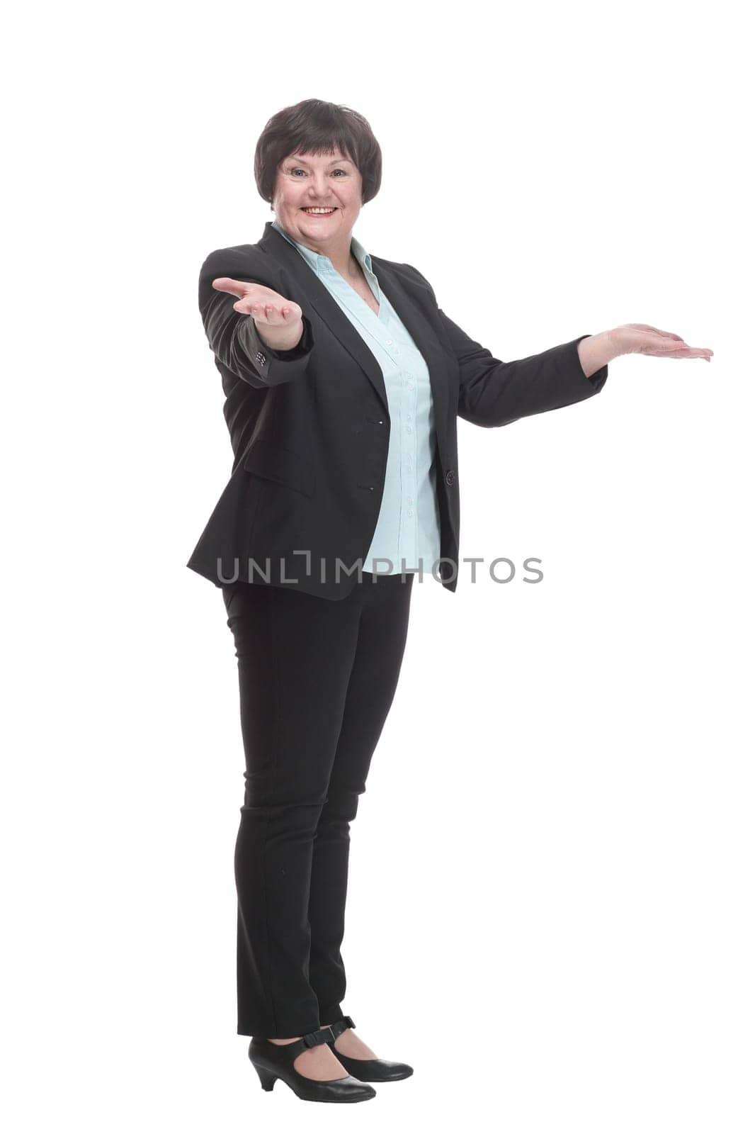 Mature business woman in a black pantsuit . isolated on a white background.