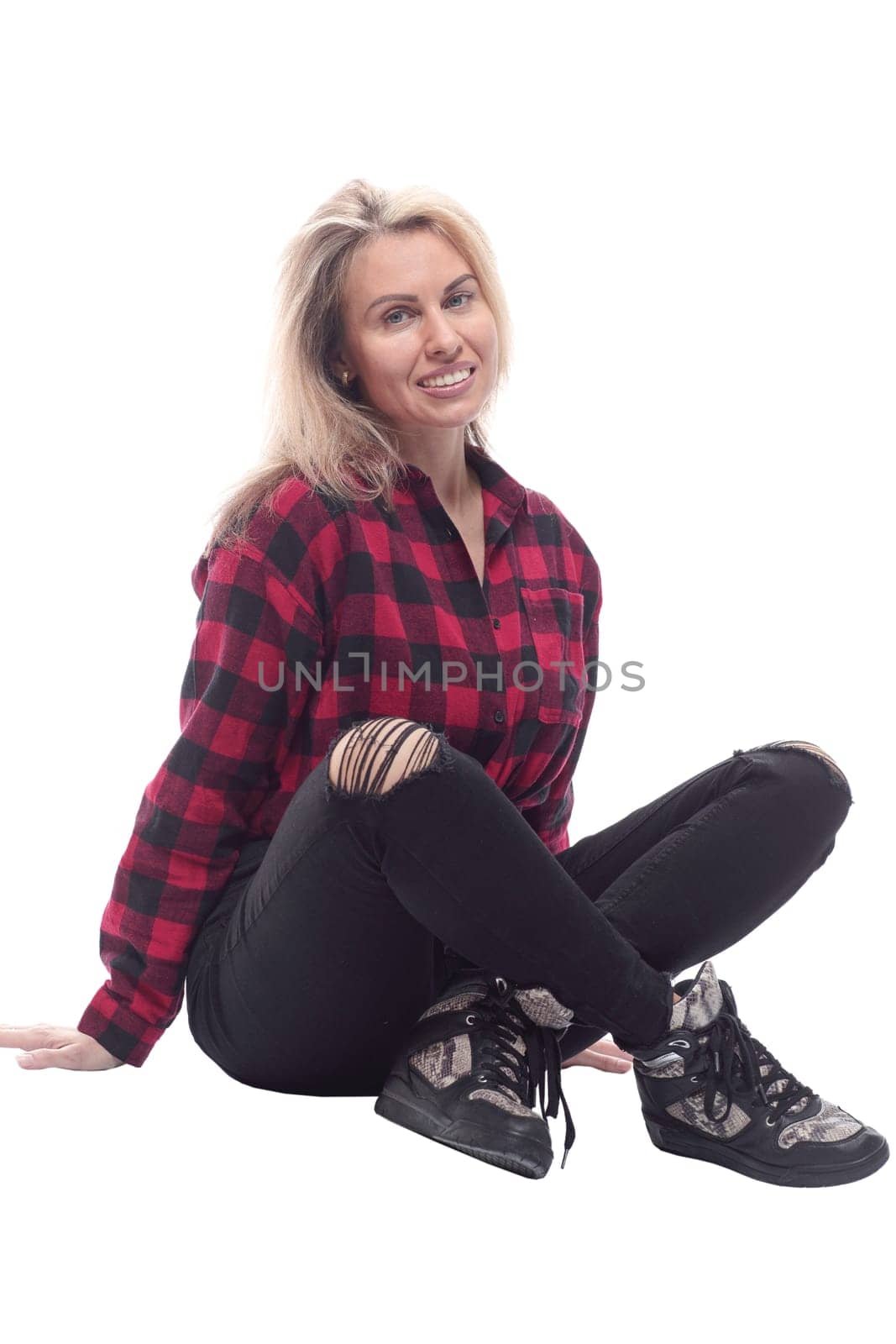 in full growth. attractive young woman sitting on the floor and looking at you . isolated on a white background.