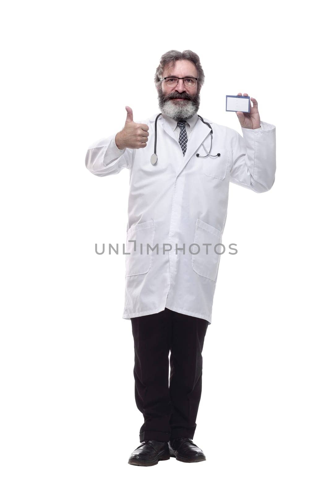in full growth. friendly doctor therapist showing his visiting card . isolated on a white background
