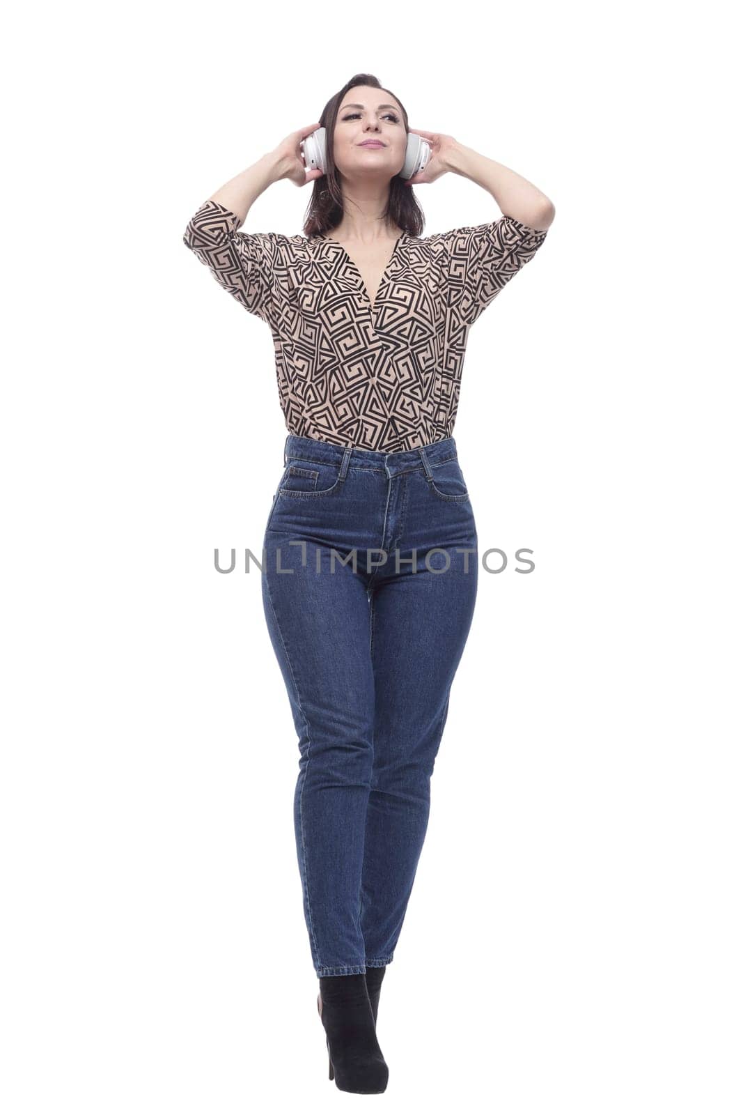 attractive young woman listening to music through headphones. isolated on a white background.