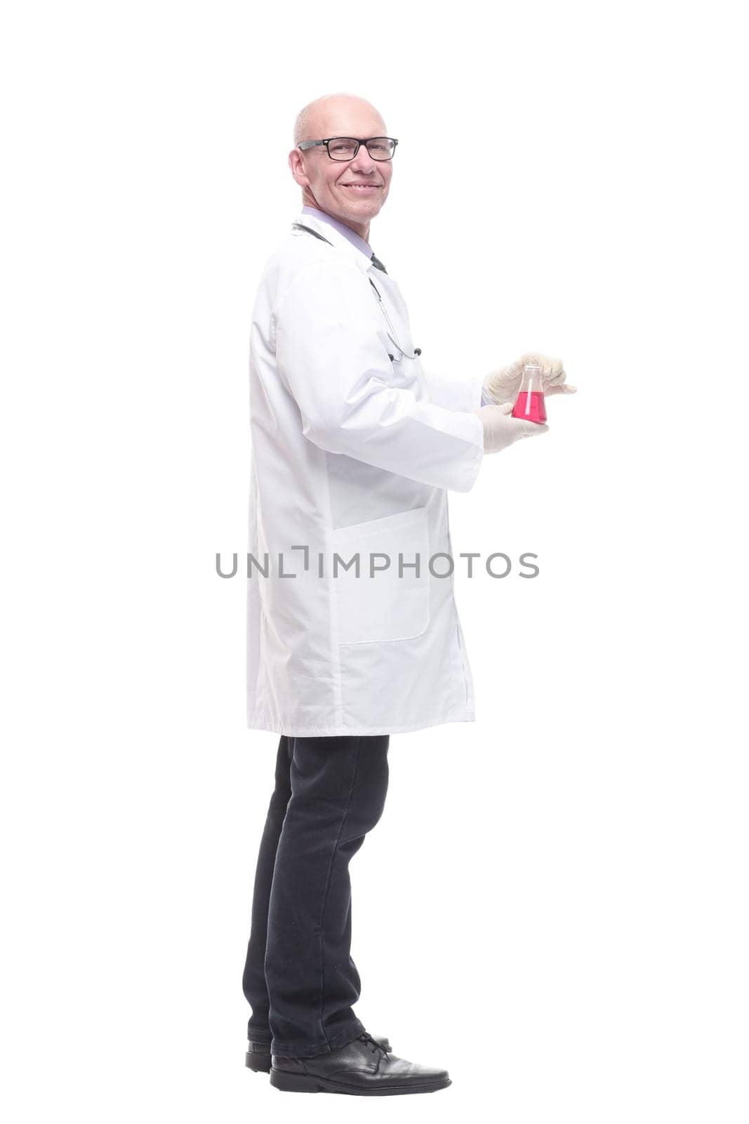 in full growth. competent doctor with a laboratory flask. isolated on a white background.
