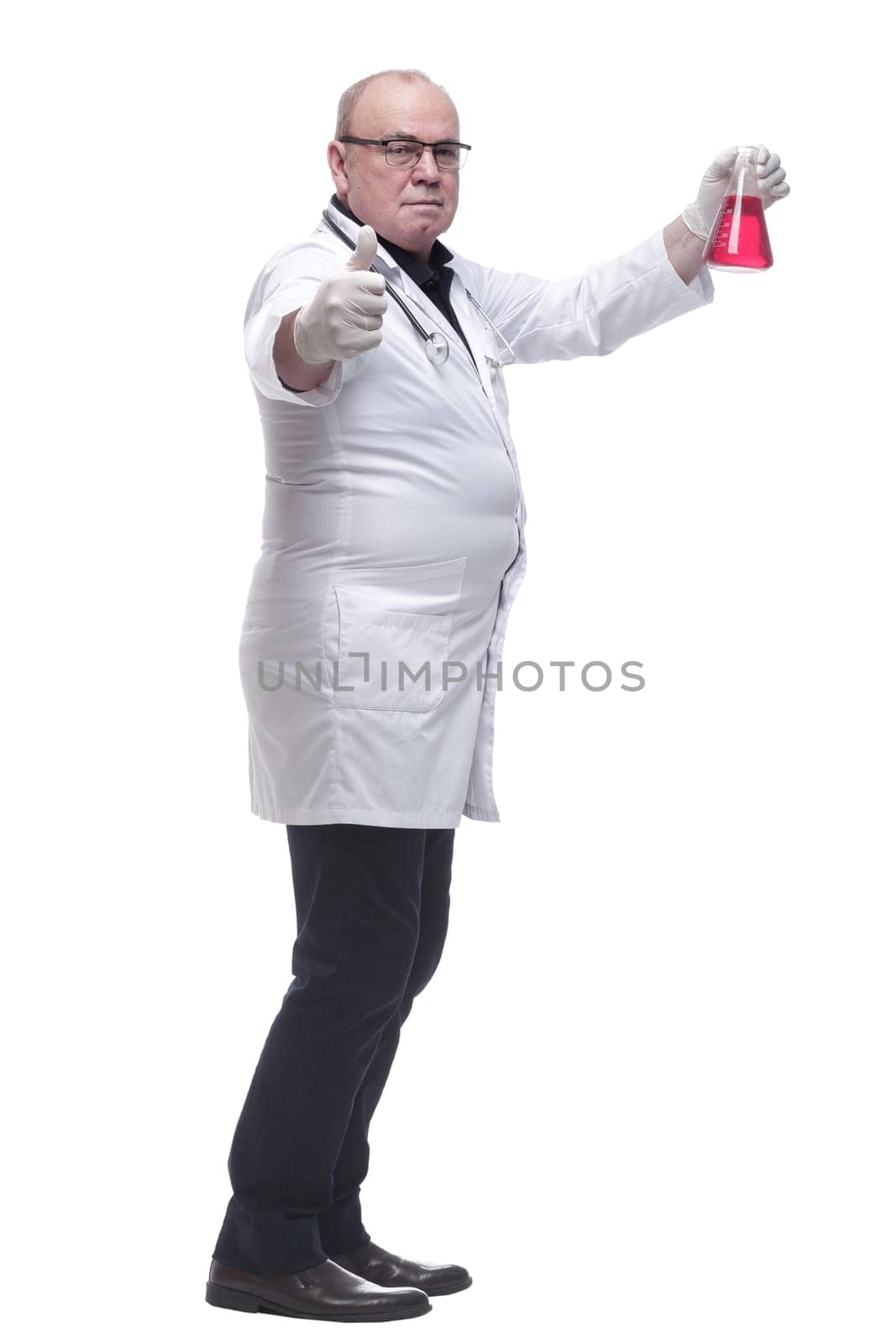 side view. doctor therapist looking at a flask of liquid . isolated on a white background