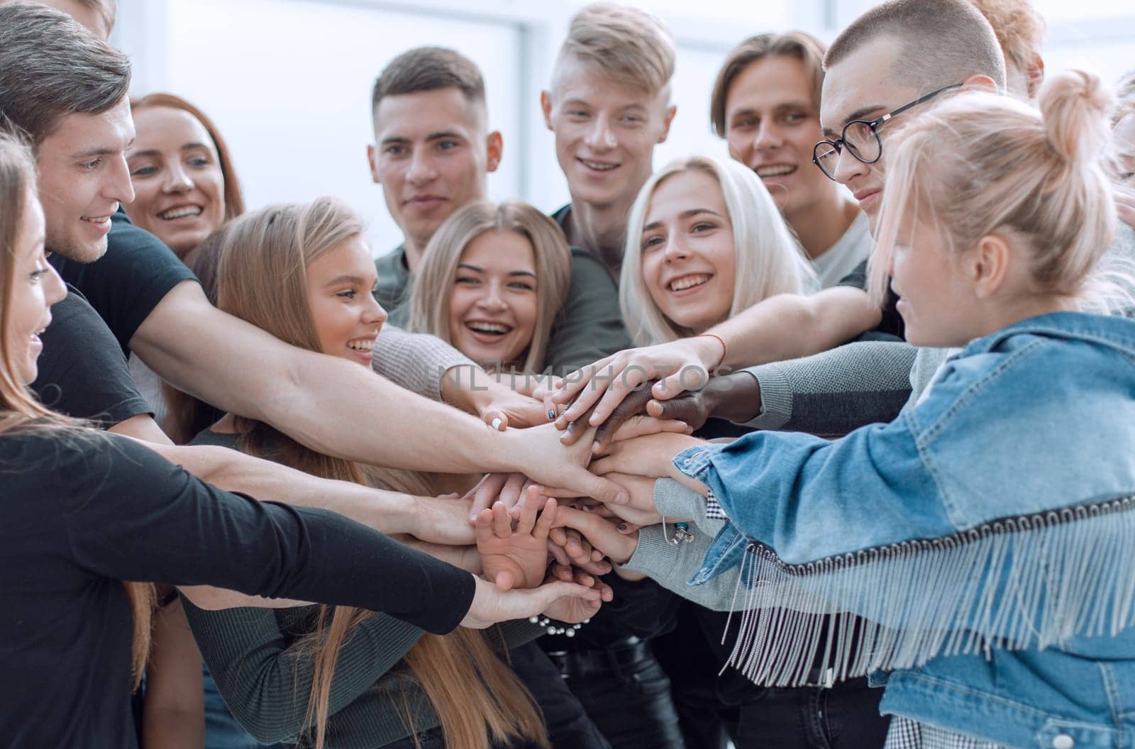 close up. a group of young people showing their unity. the concept of teamwork