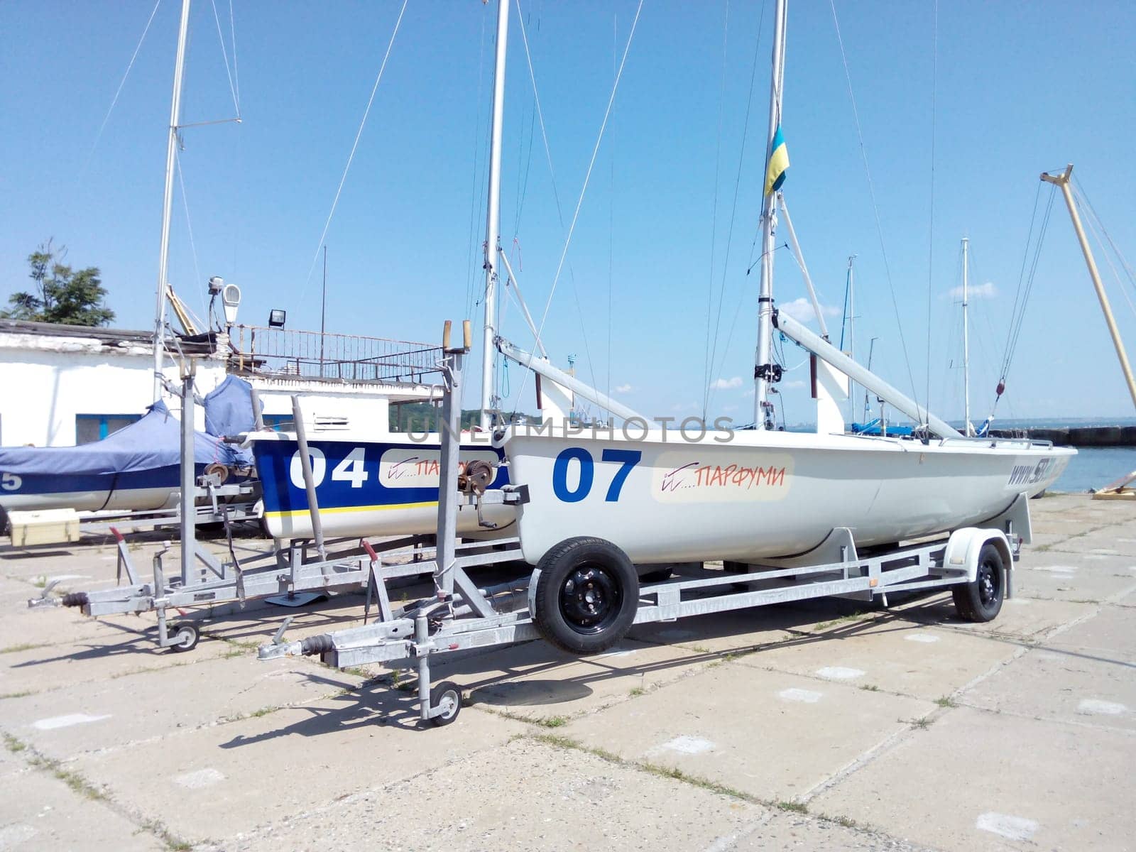 FINA's small yachts are parked on trailers in the harbor. High quality photo
