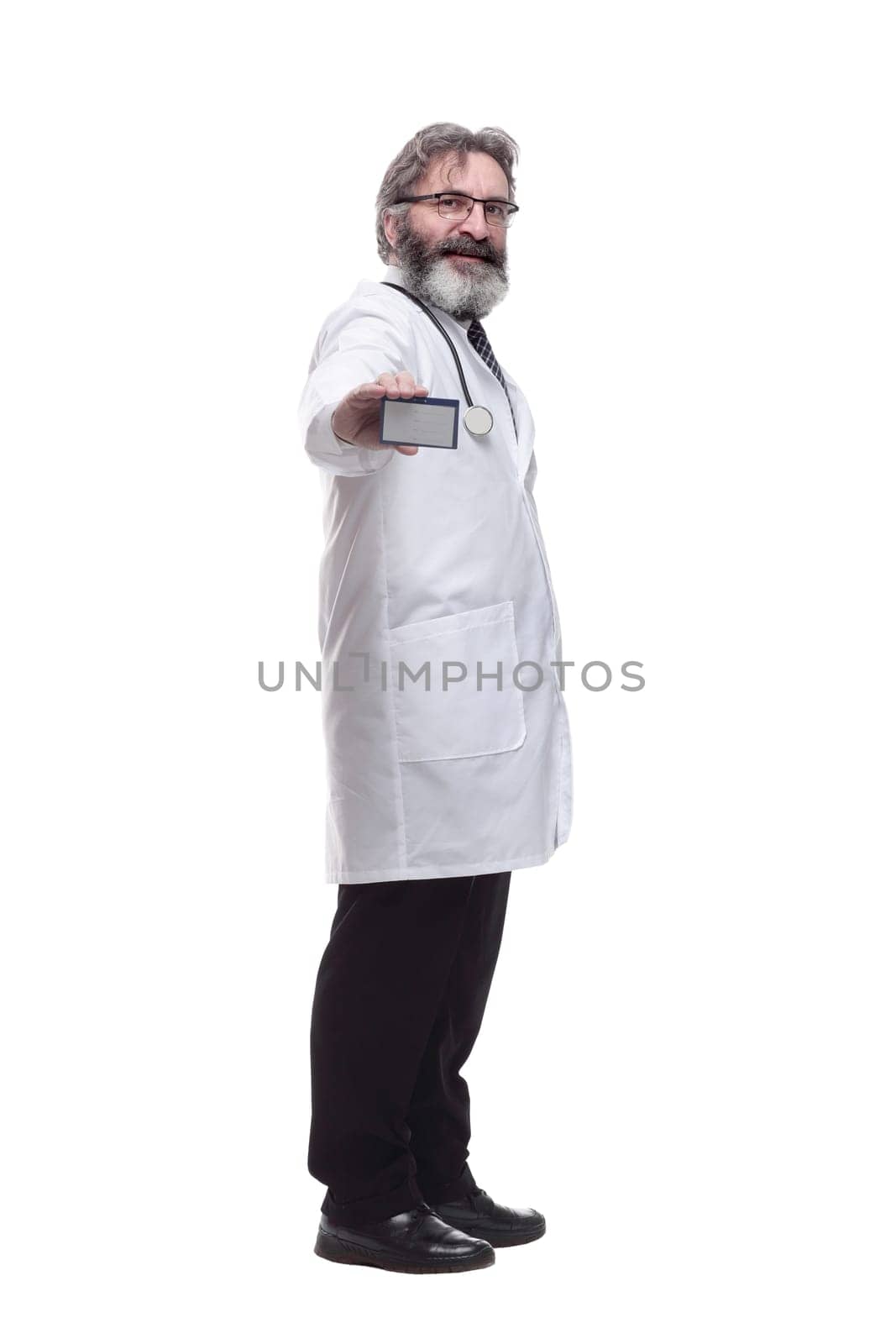 in full growth. qualified doctor showing his visiting card . isolated on a white background