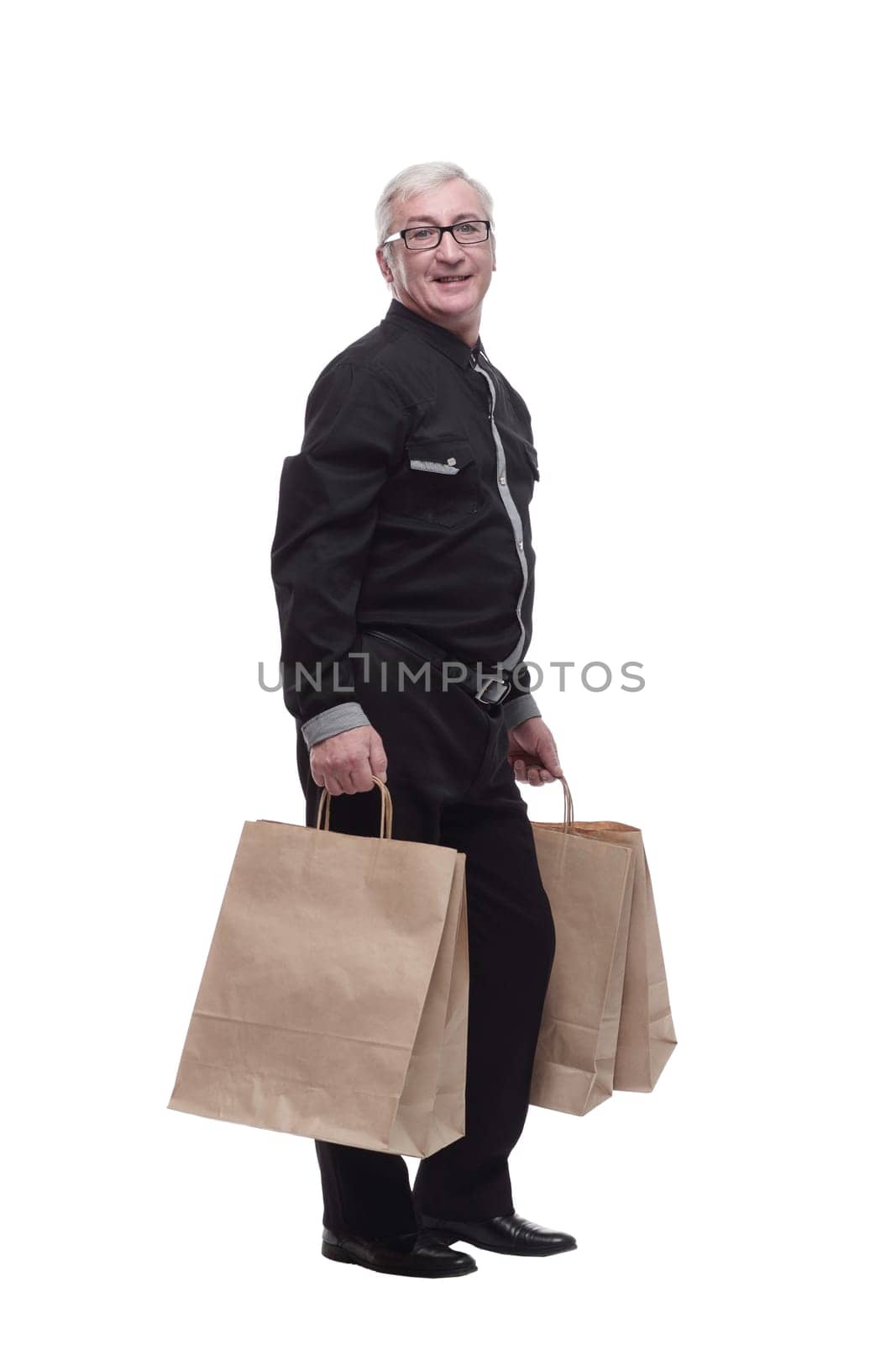 in full growth. happy casual man with shopping bags. by asdf