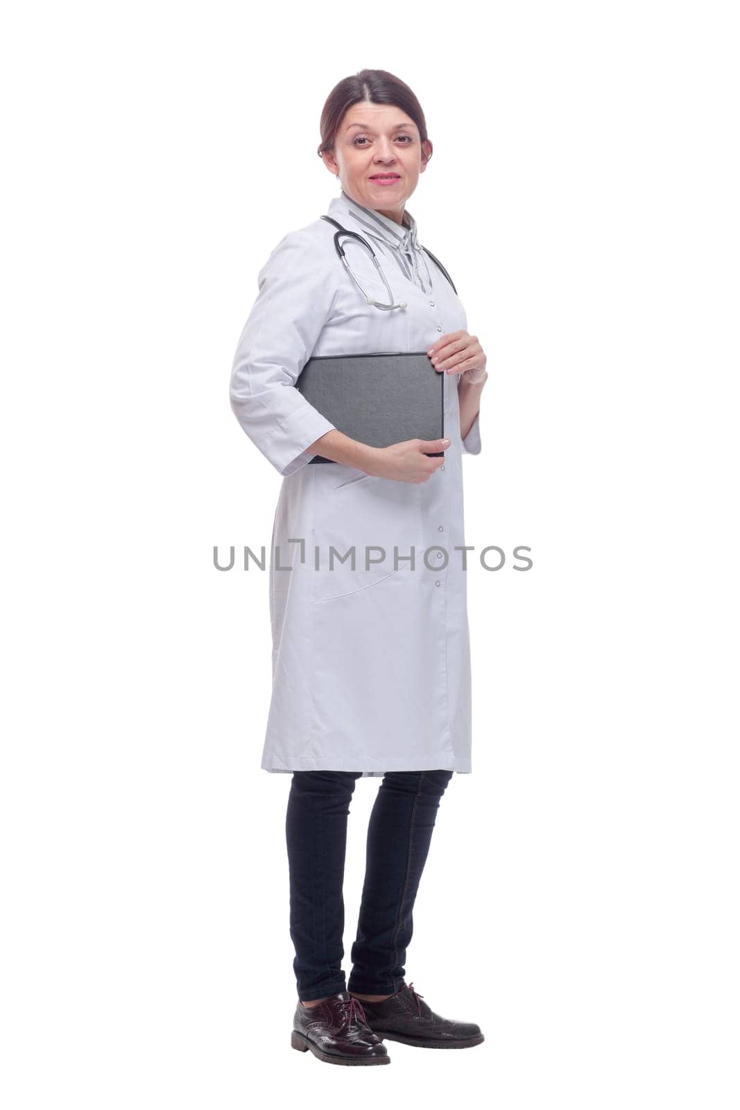 Smiling female doctor with lab coat in her office holding a clipboard with medical records by asdf