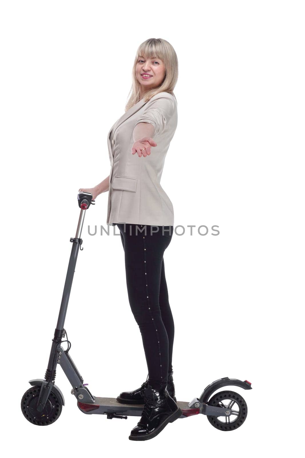 side view.happy adult woman with electric scooter looking at you . isolated on a white background.
