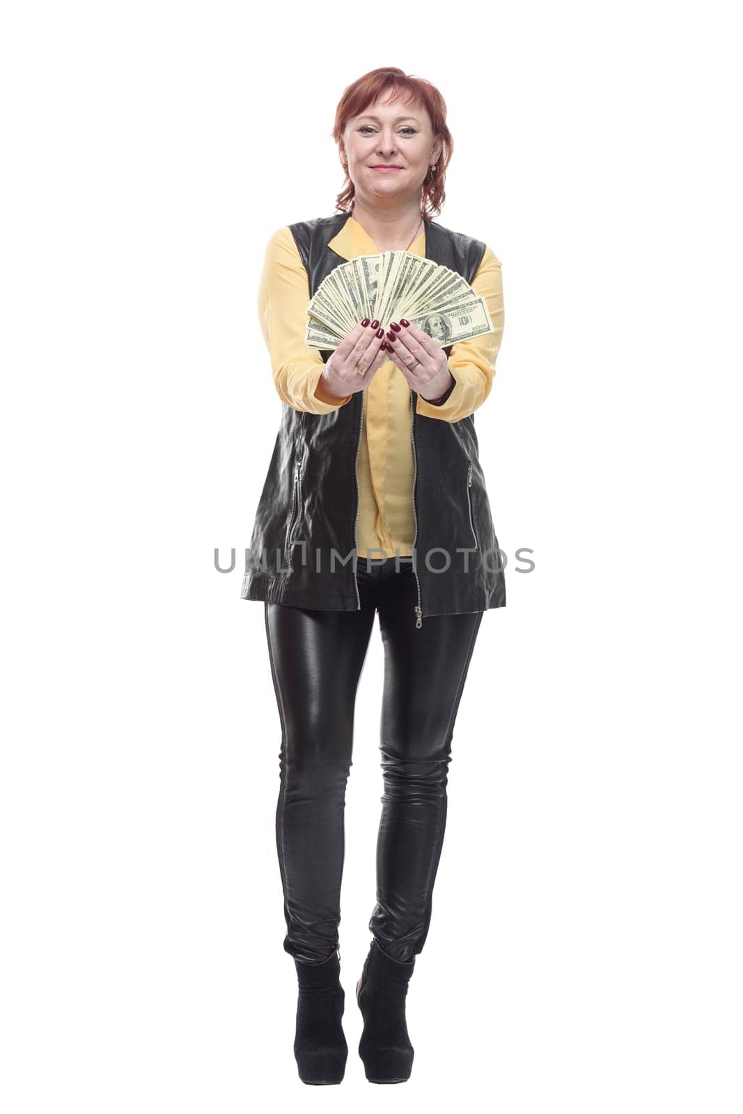 happy mature woman with a fan of banknotes. isolated on a white background.