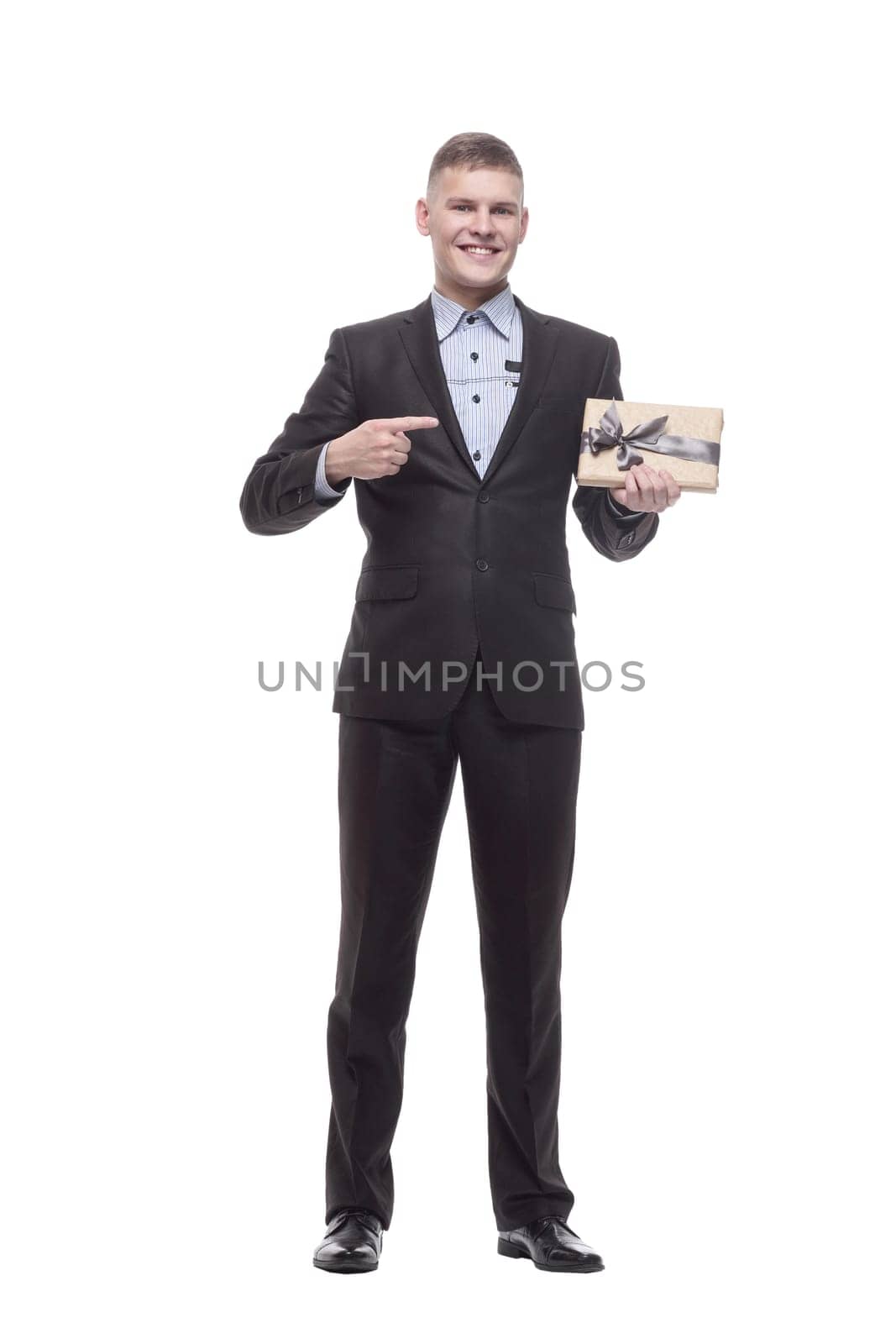 in full growth. happy young businessman with a gift box . by asdf