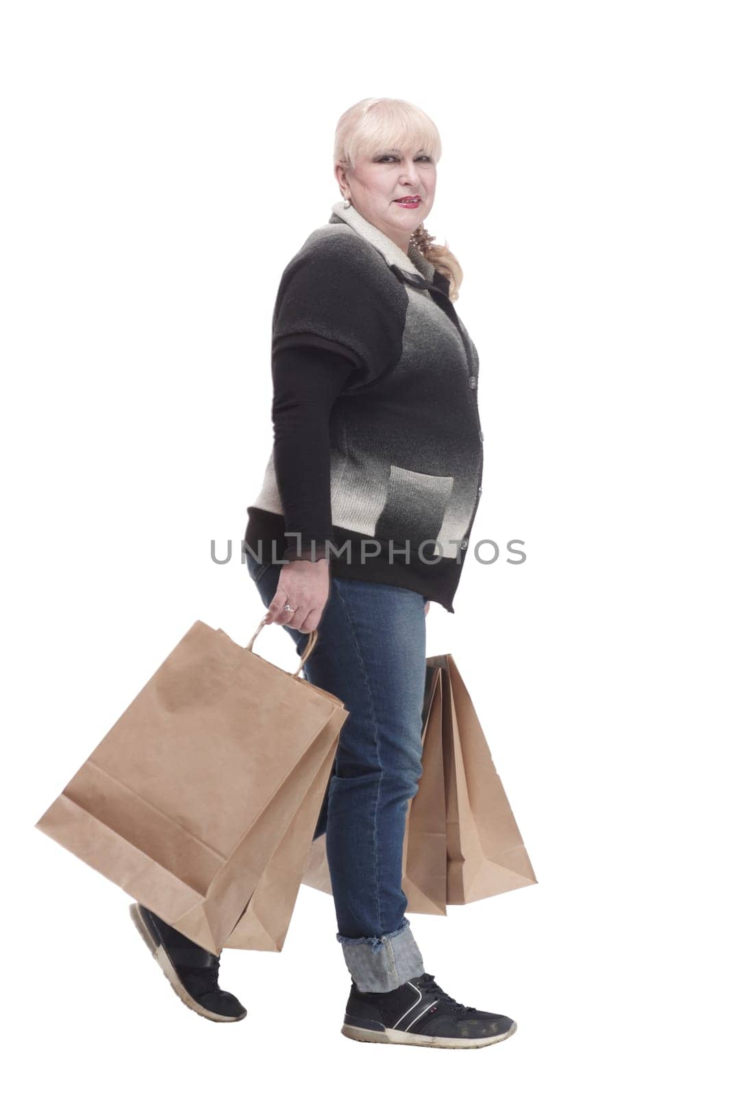 full-length. casual woman in jeans with shopping bags. isolated on a white background.