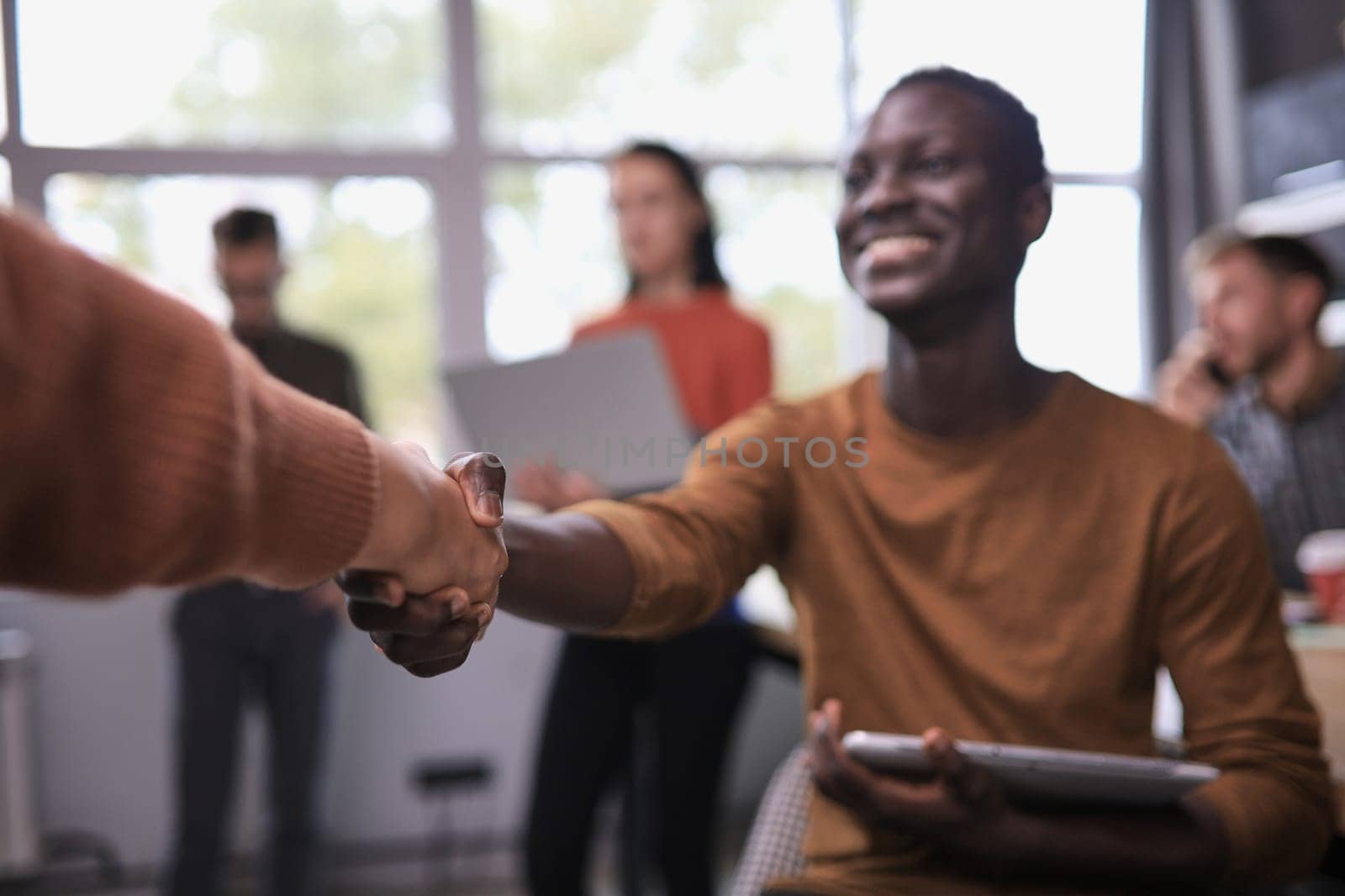 Business people shaking hands in office by asdf