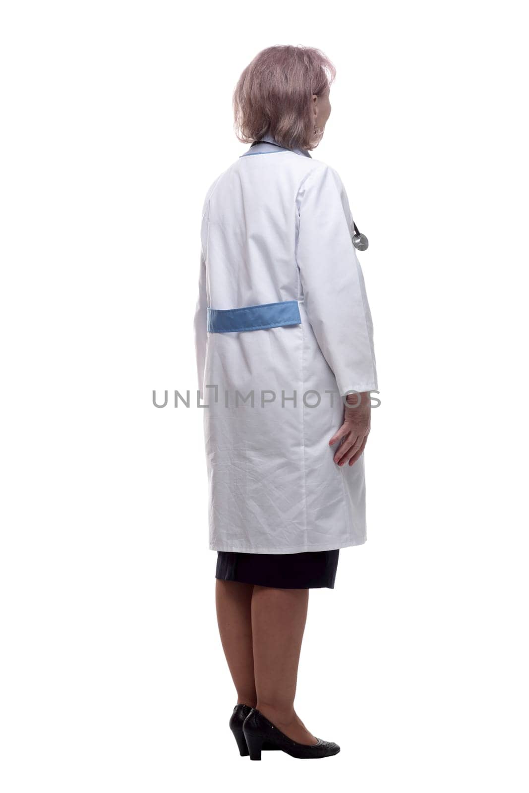 rear view. a woman doctor reading an ad on a white wall . isolated on a white background