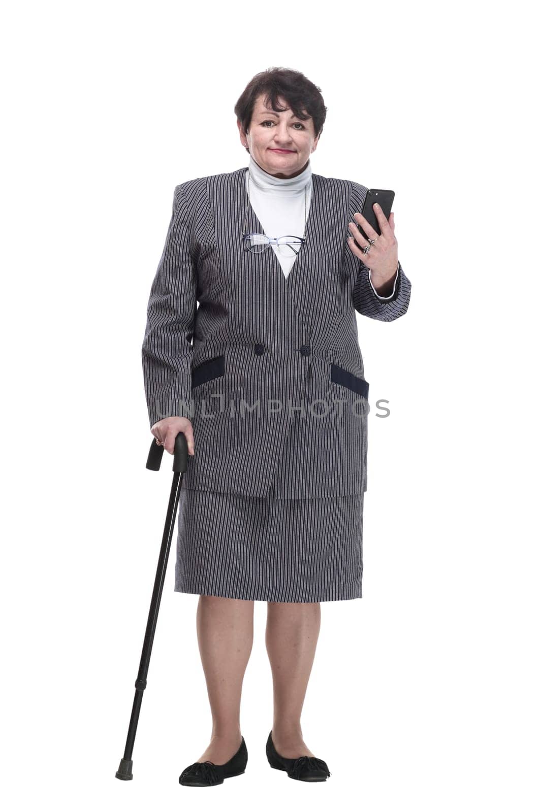 in full growth. casual elderly woman with a mobile phone. isolated on a white background.