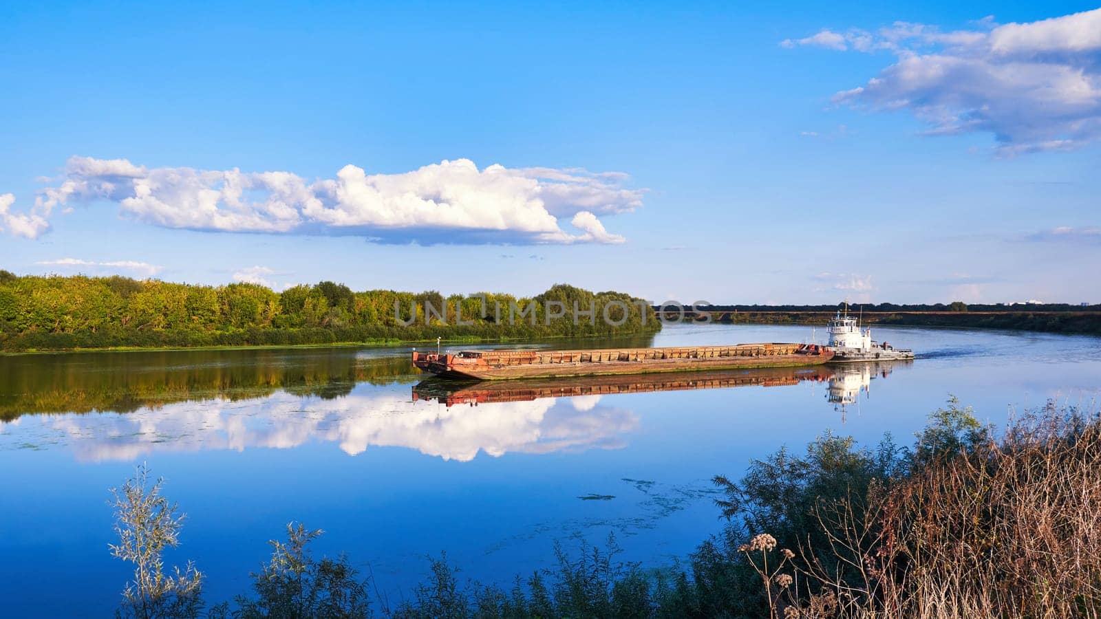 Ryazan, Russia - September 5, 2023: A barge floating on the Oka River. River freight transport