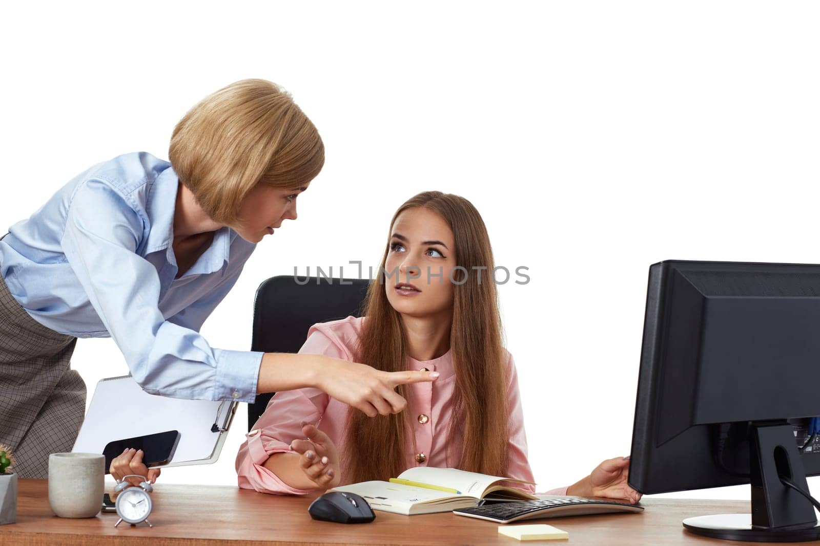 Two business woman discuss project presentation in office.