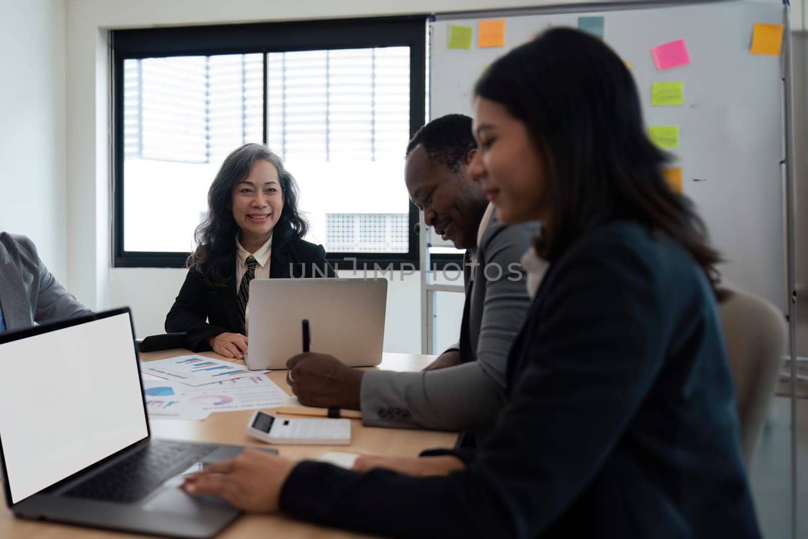 Group businesspeople diverse ethnicity on analysis financial data report paper on meeting table discussion to plan for data analysis at office concept diversity ethnicity.