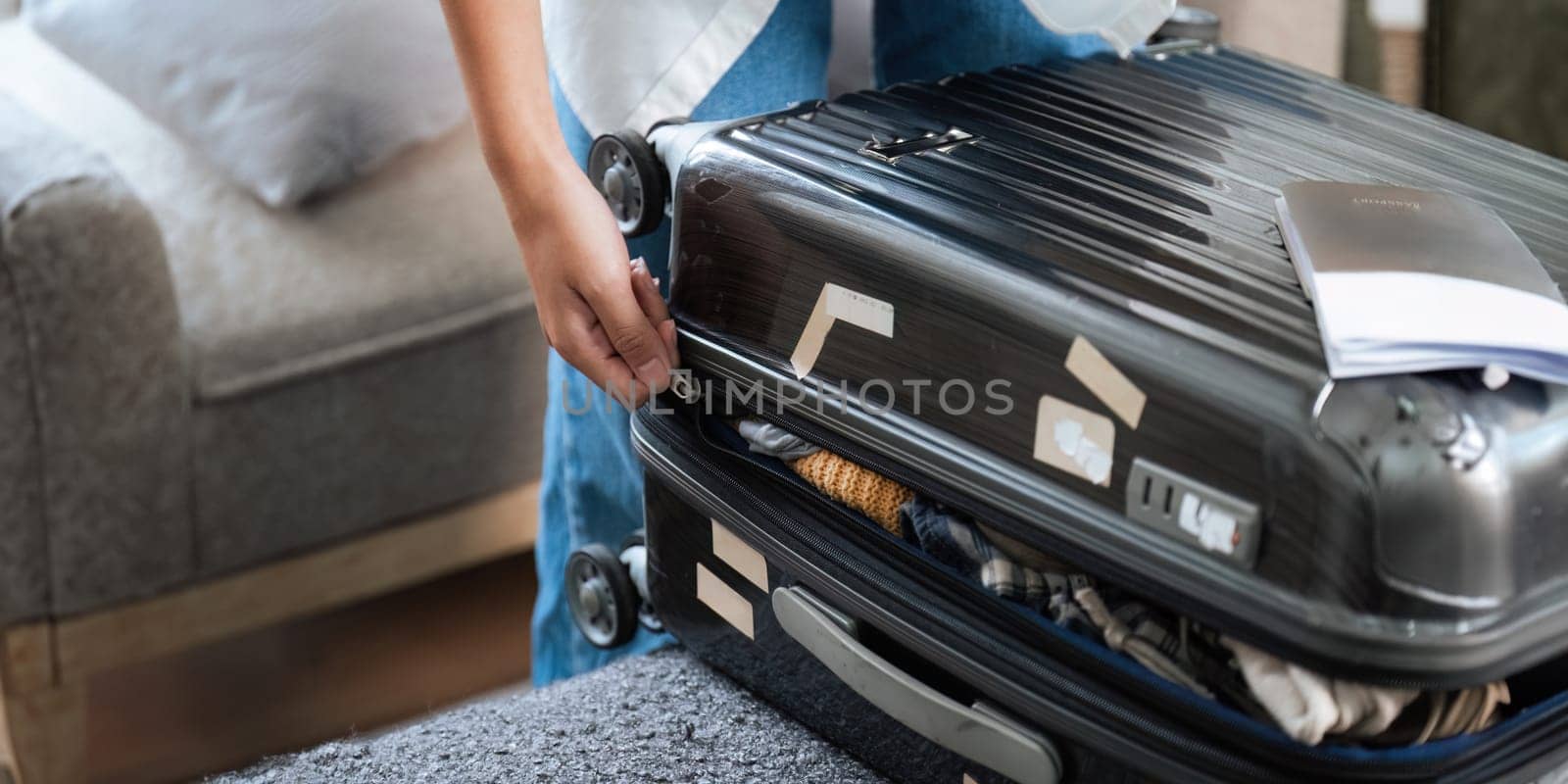 Close up young asian woman traveler pack bags prepare for the travel season vacation, concept travel lifestyle active journey and trip travel, passport.