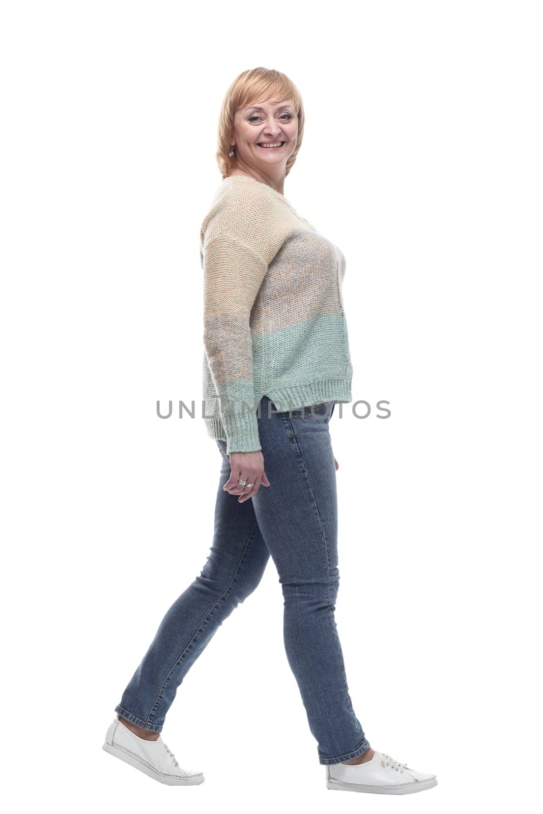 full-length. casual woman in jeans striding forward. isolated on a white background.