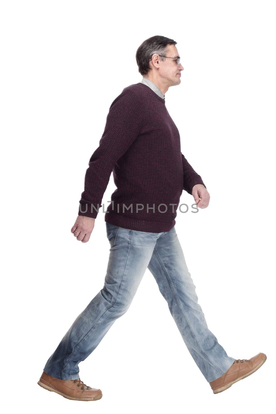 casual man in jeans and jumper striding forward by asdf