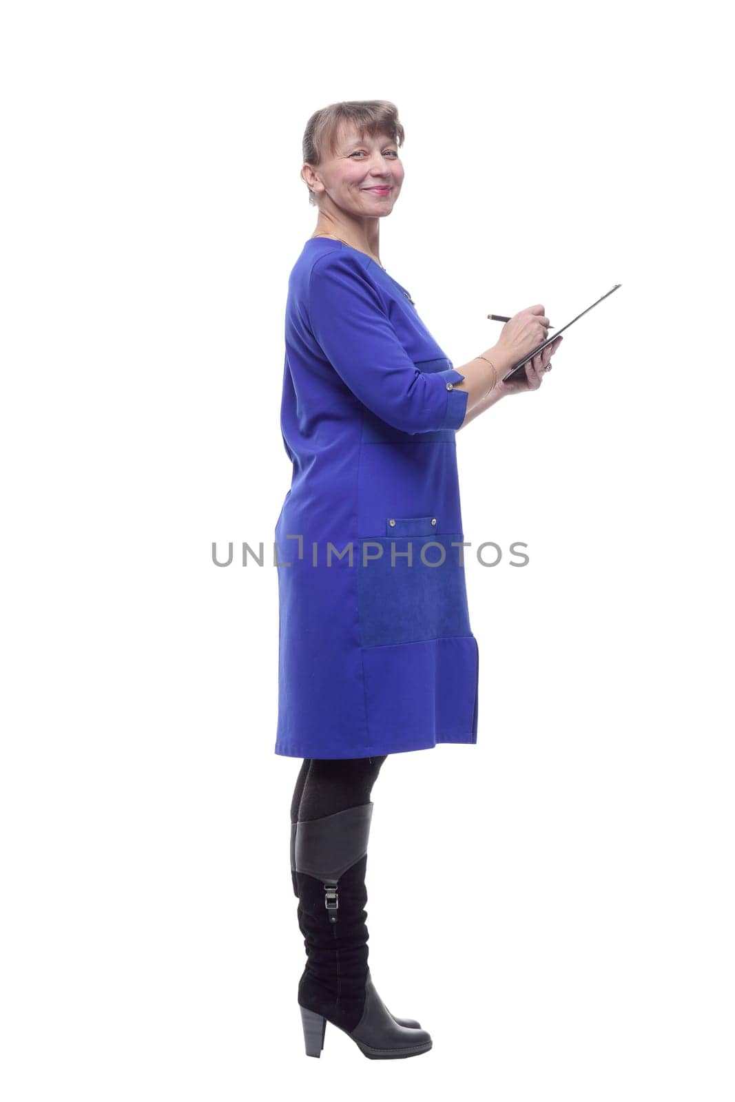 Pretty blonde business woman holding clipboard over isolated background and writing something on it
