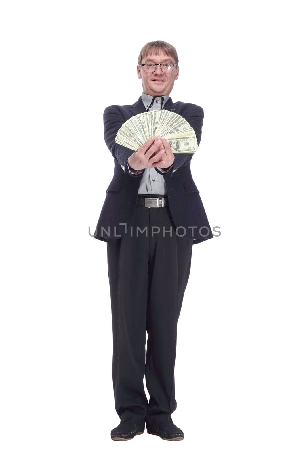 full-length. business man with a bundle of dollar bills looking at you. isolated on a white background.