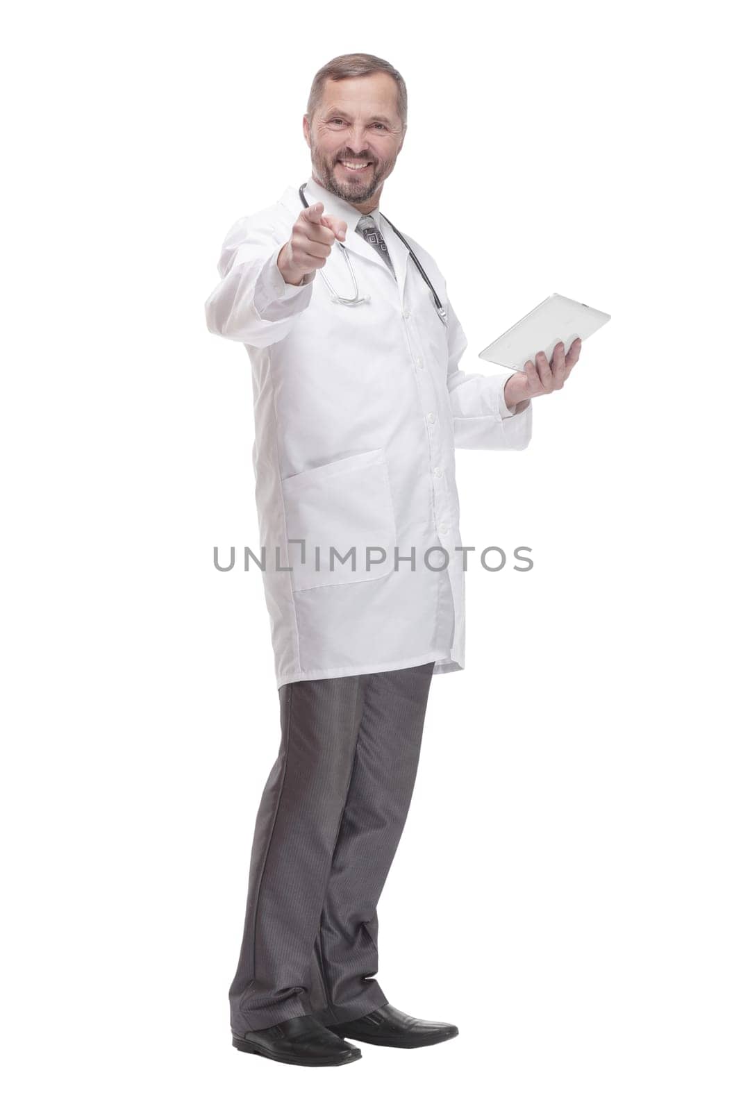 in full growth. smiling doctor with a digital tablet . isolated on a white background.