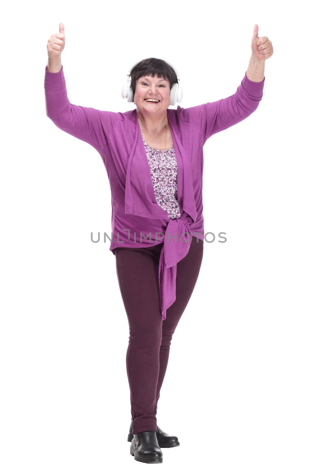 happy senior woman listening to music through headphones. isolated on a white background.