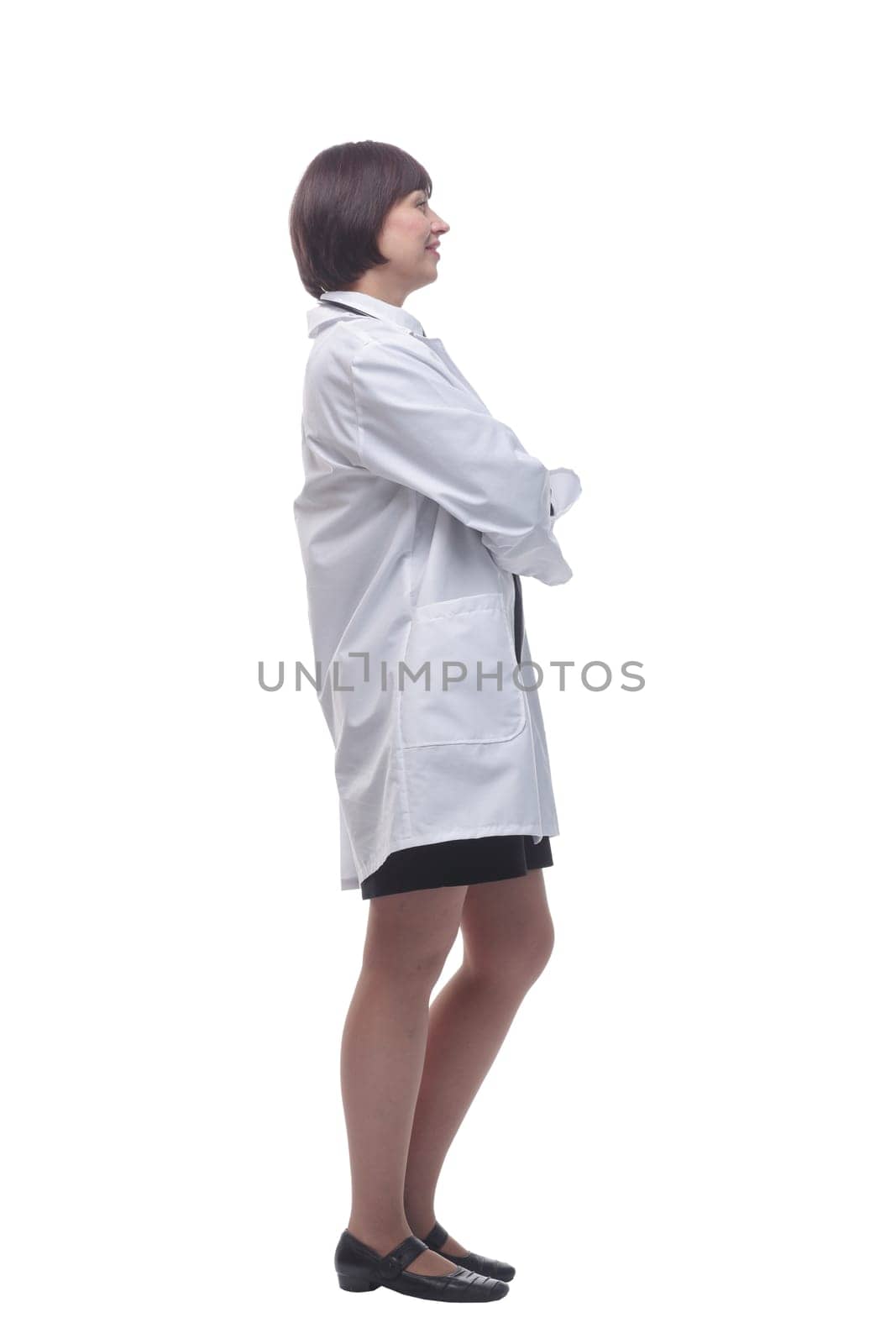 side view. confident female doctor with stethoscope looking at you. isolated on white background.