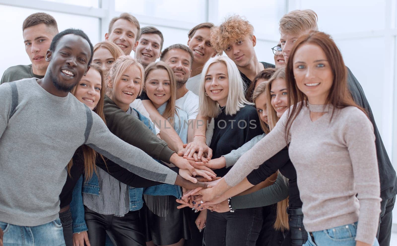 close up. a group of young people making a tower out of their hands.