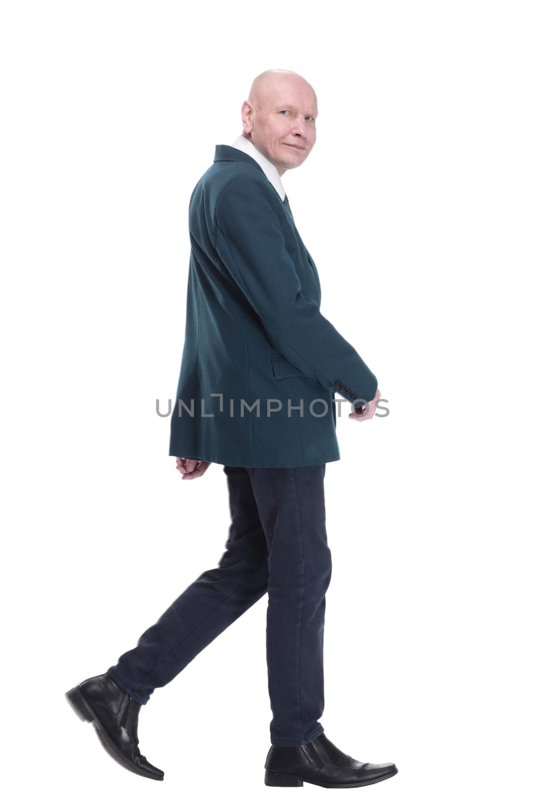 Mature business man striding forward. isolated on a white background. by asdf