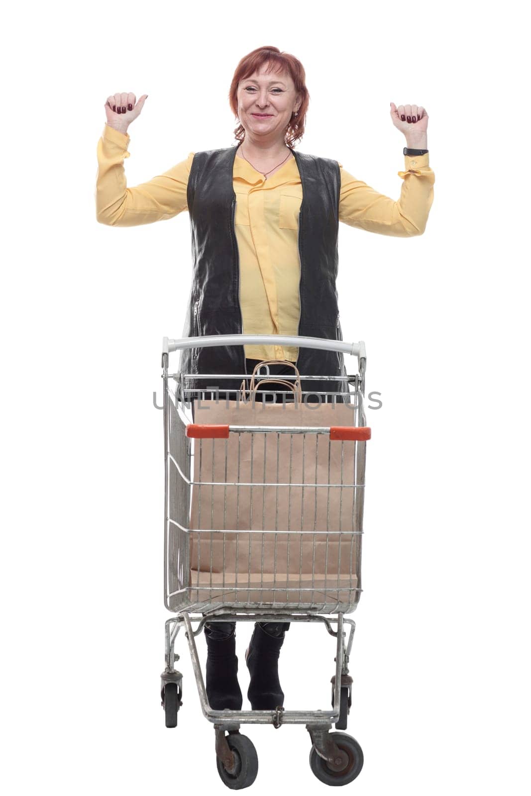 happy mature woman with shopping cart. isolated on a white background.