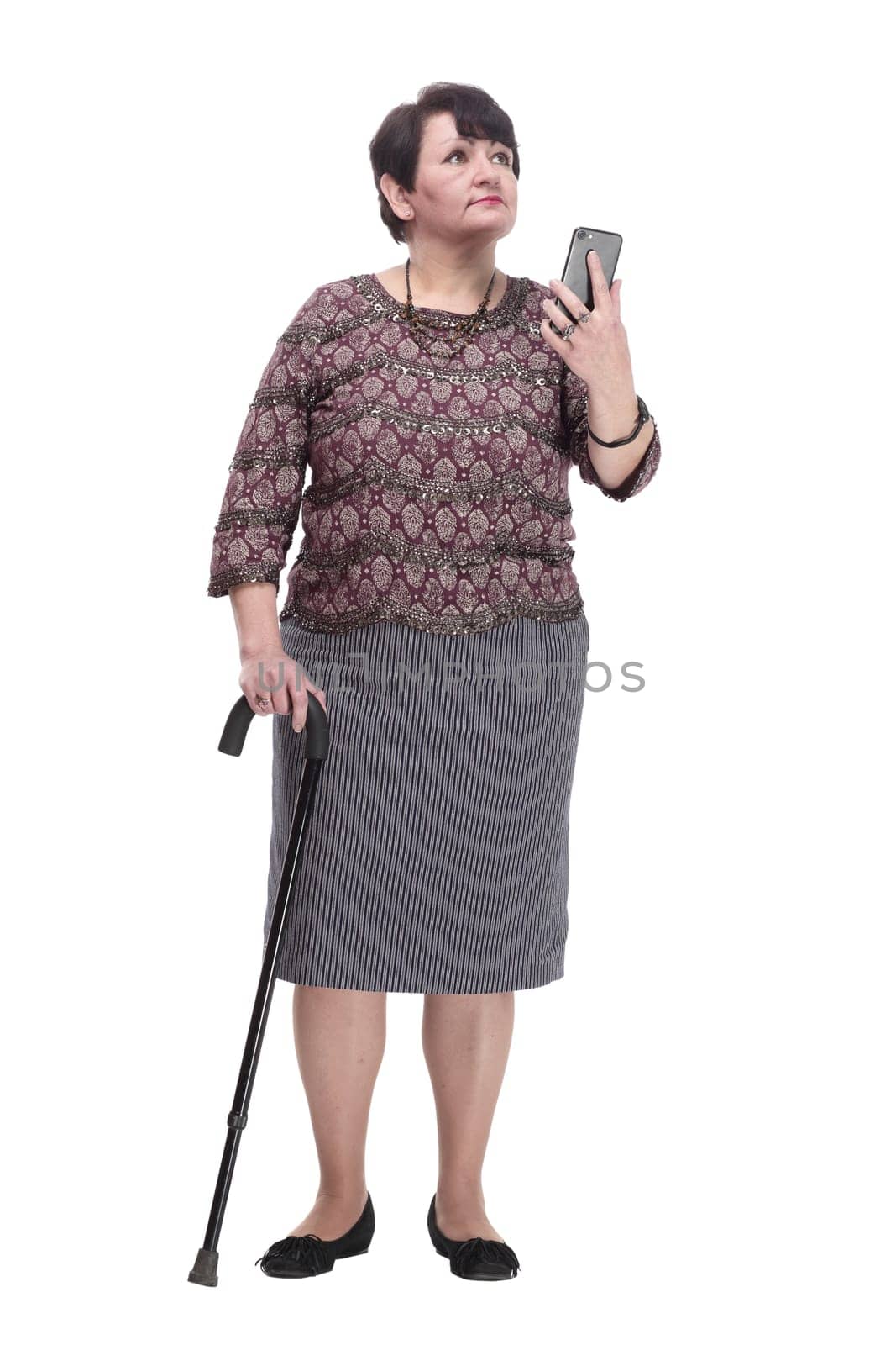 full-length. casual elderly woman with a mobile phone. isolated on a white background.