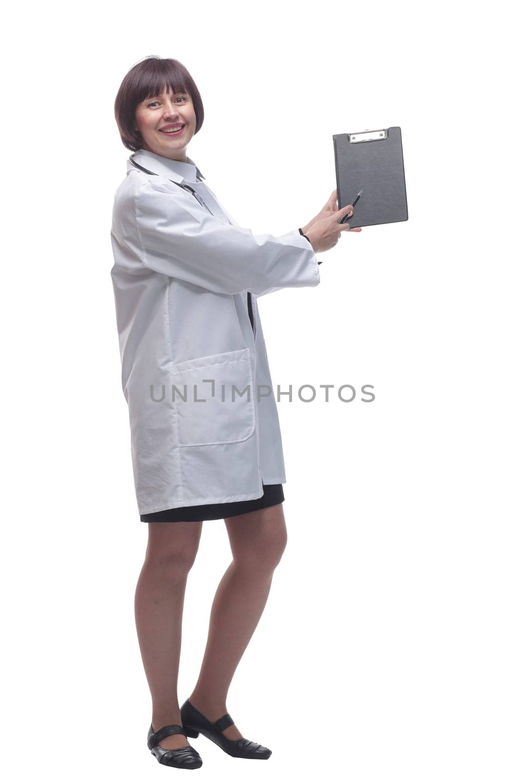 side view. female medic making notes to the clipboard . isolated on a white background.