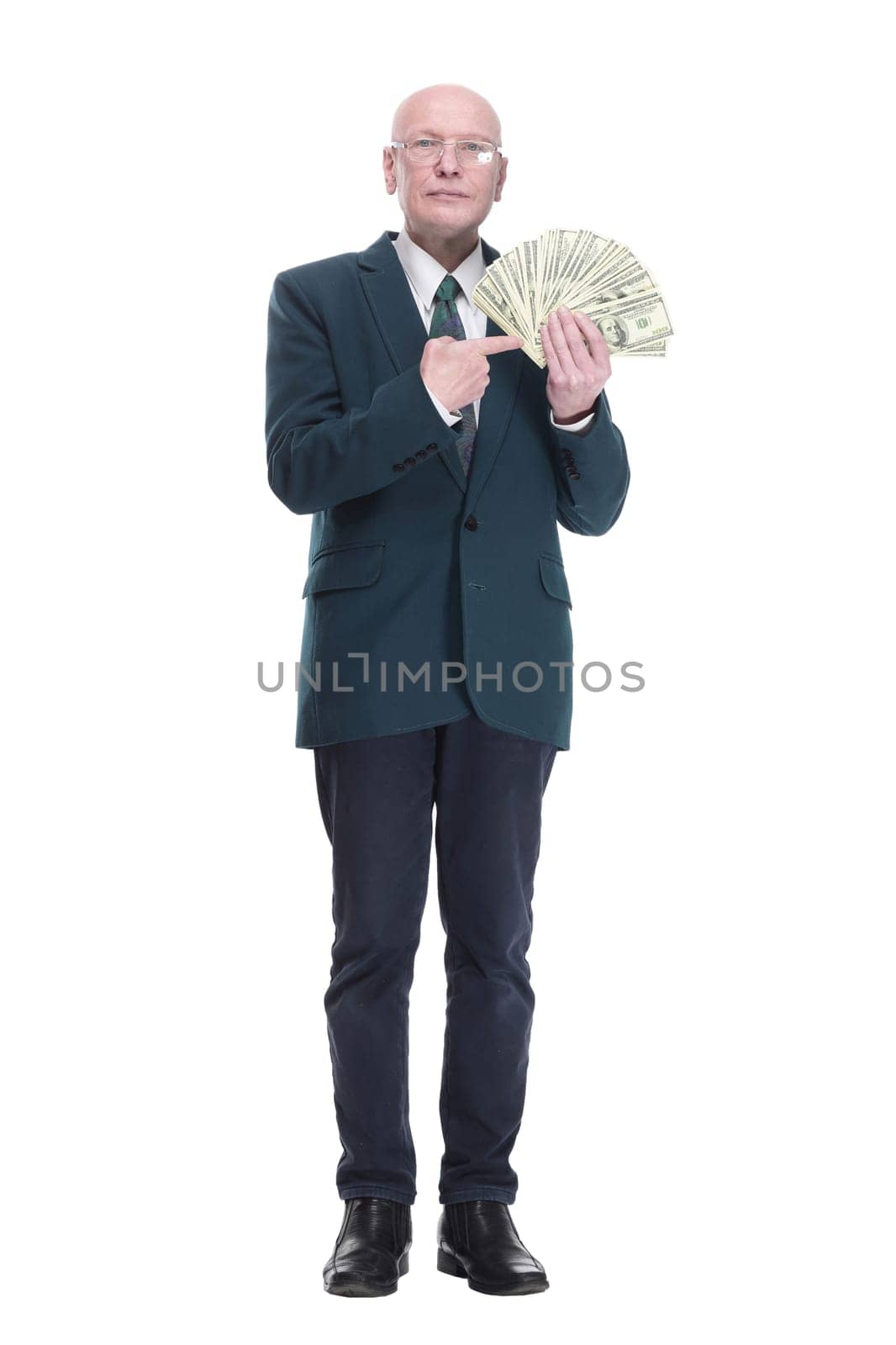 side view. personable business man with a wad of dollar bills. isolated on a white background.